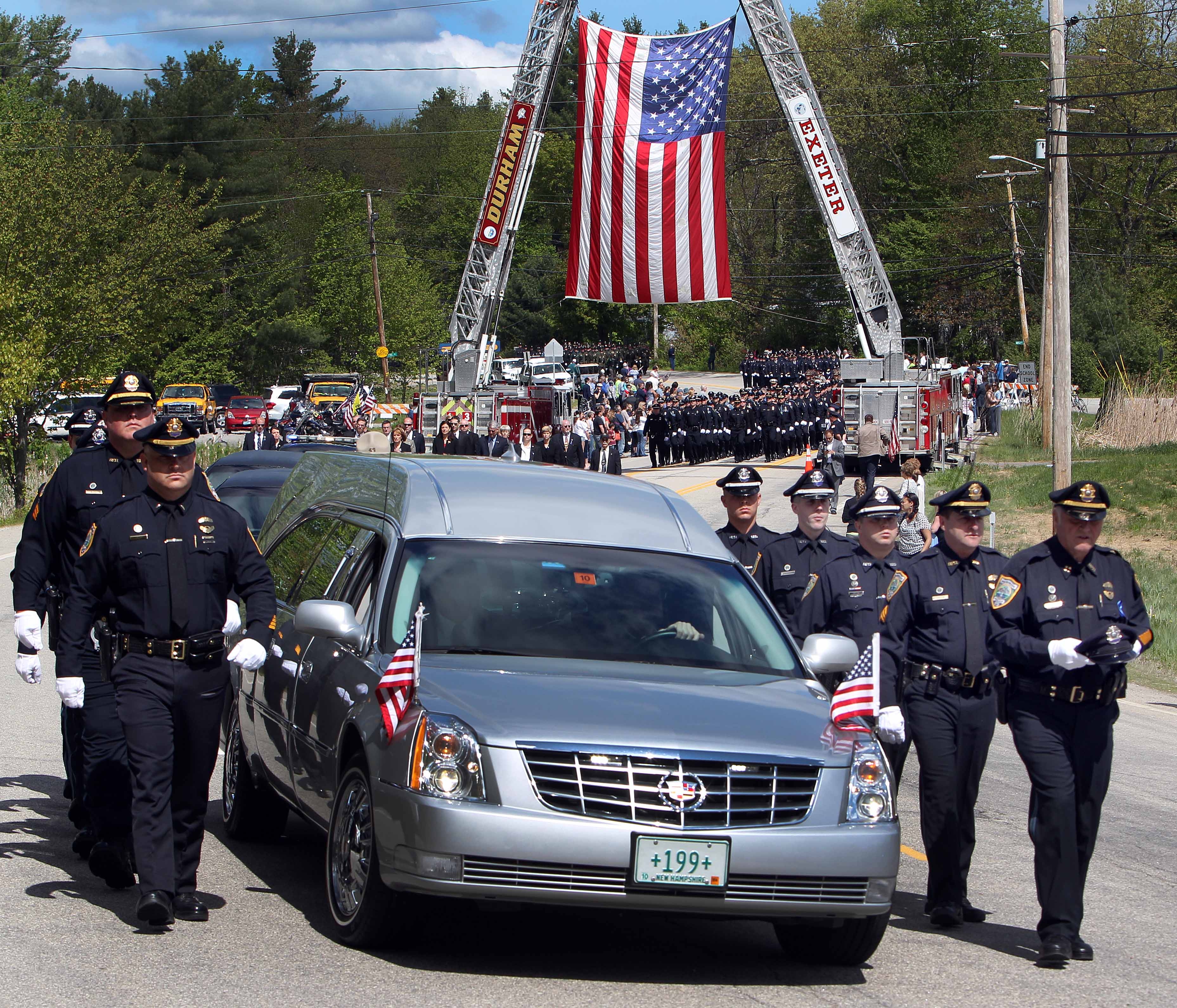 A hearse carrying the body of Brentwood police Officer Stephen Arkell made its way to a memorial service Wednesday in Exeter, N.H.