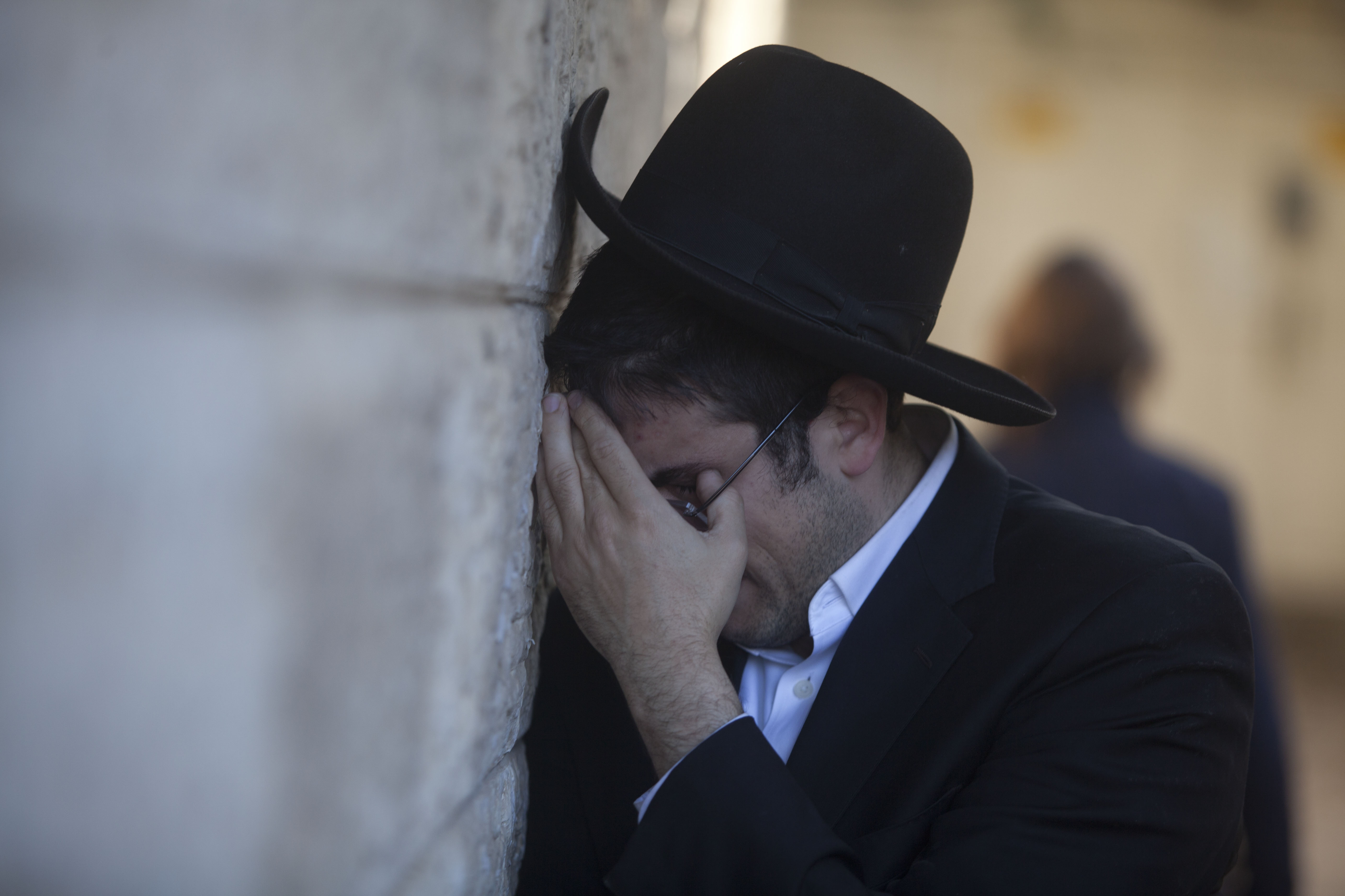 A man cried during the funeral of Rabbi Mosheh Twersky, one of four men killed in an attack by two Palestinians on Tuesday. Twersky had ties to the Boston area.
