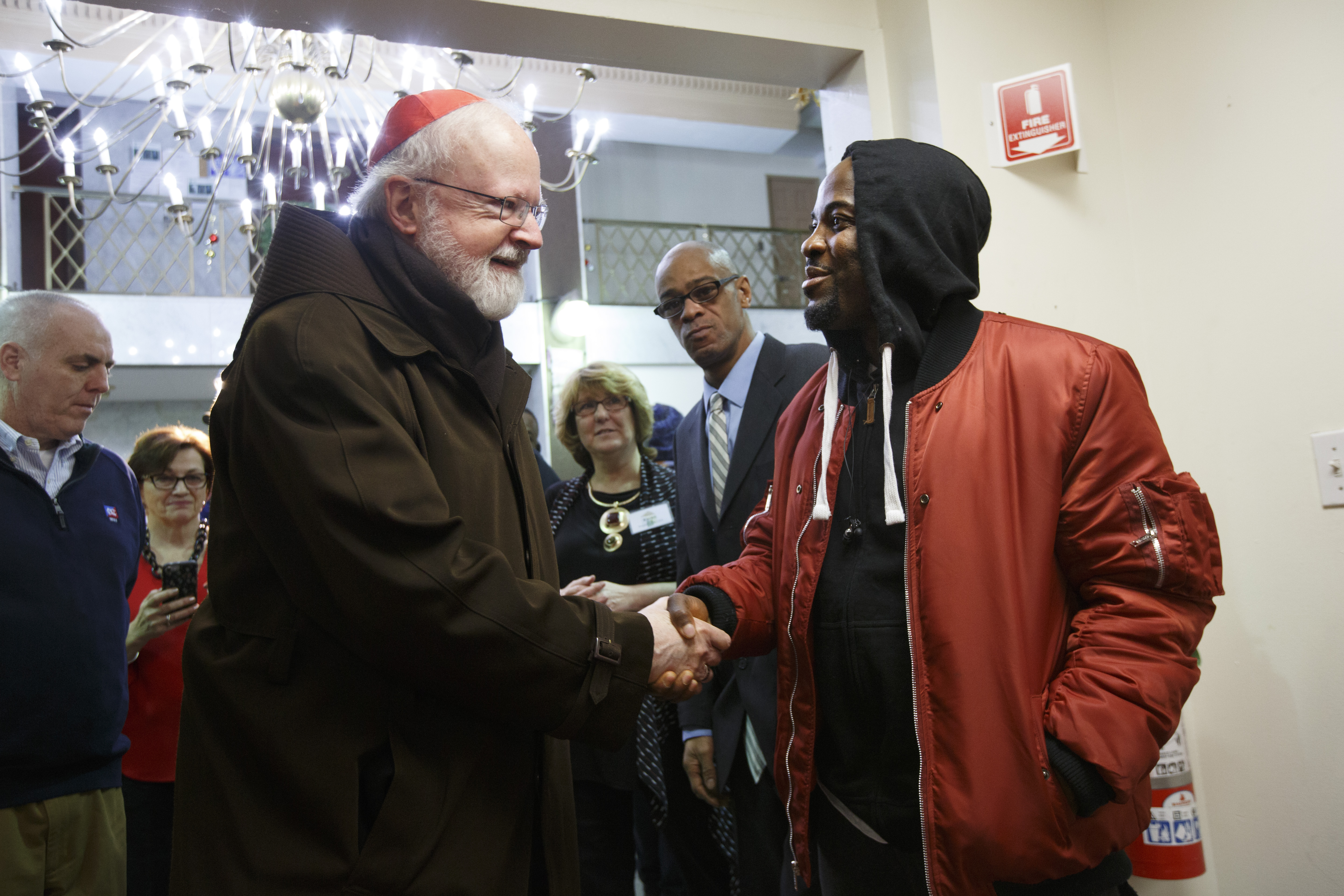 Roland Yarpah (right) greeted Cardinal Sean O'Malley.