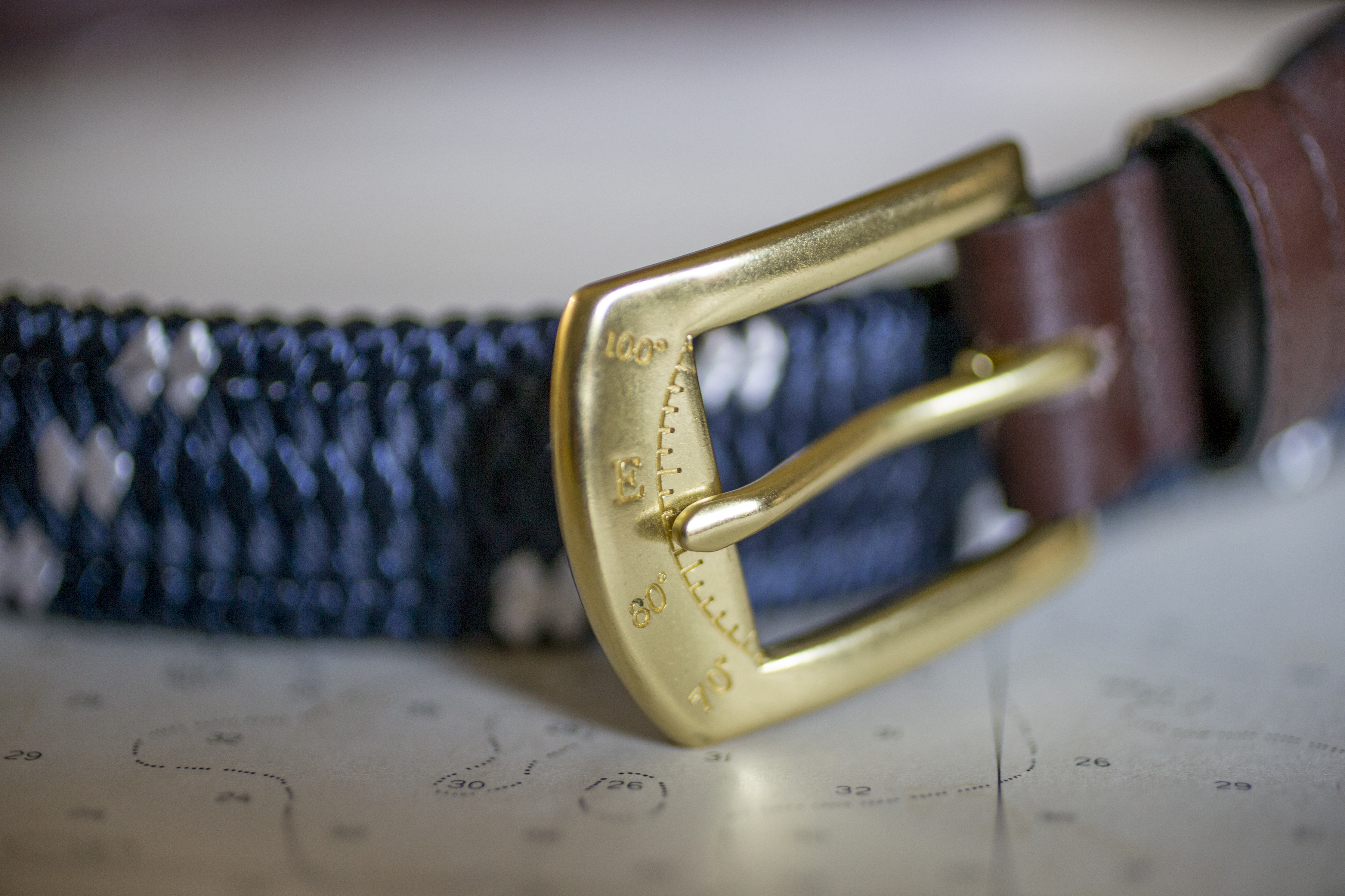A solid brass compass buckle on a belt made from rigging line by York River Traders.