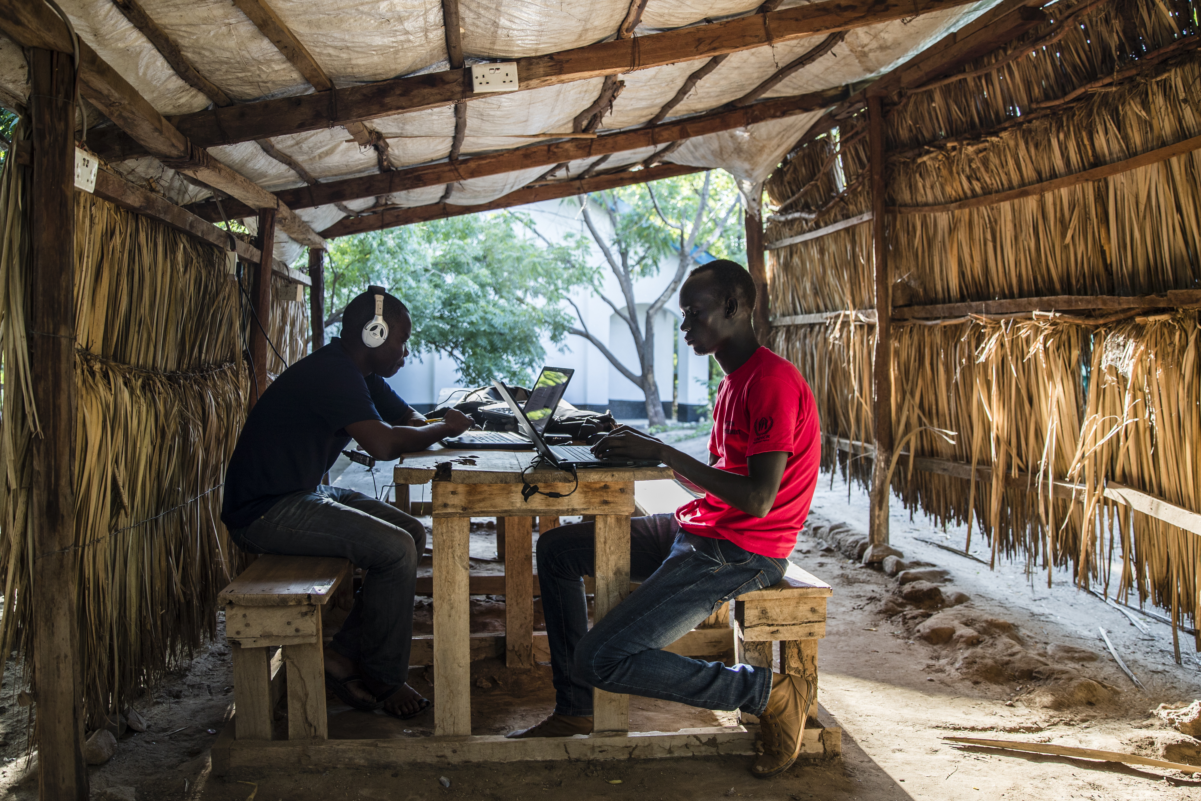 Students Jimmy Onono (left) and Ajak Mayen went over course work on laptops at the facility where Southern New Hampshire University has a degree program in the UNHCR refugee camp.