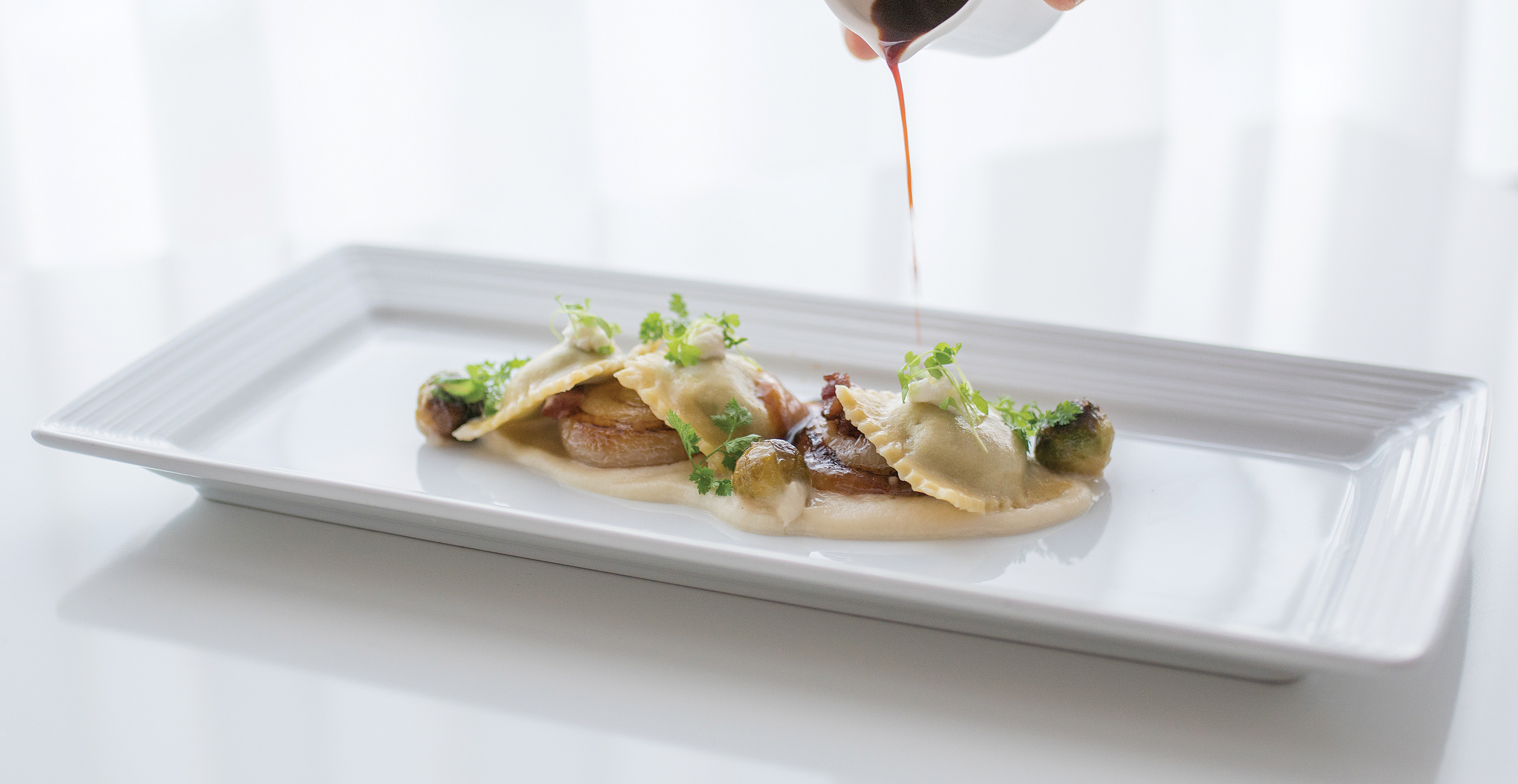Foraged mushroom ravioli with cipollini onions, melted parsnips, and caramelized Brussels sprouts at Arethusa al Tavolo