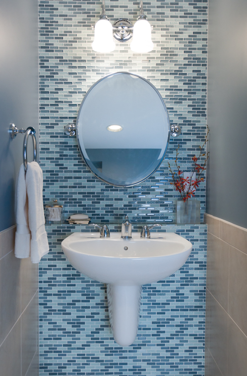 Wall-hung sinks with enclosed plumbing work for seated and standing users. A built-in wall shelf and tilting mirror provide storage for personal care items and make it easy to see oneself, regardless of height. “The Accessible Home” (The Taunton Press)