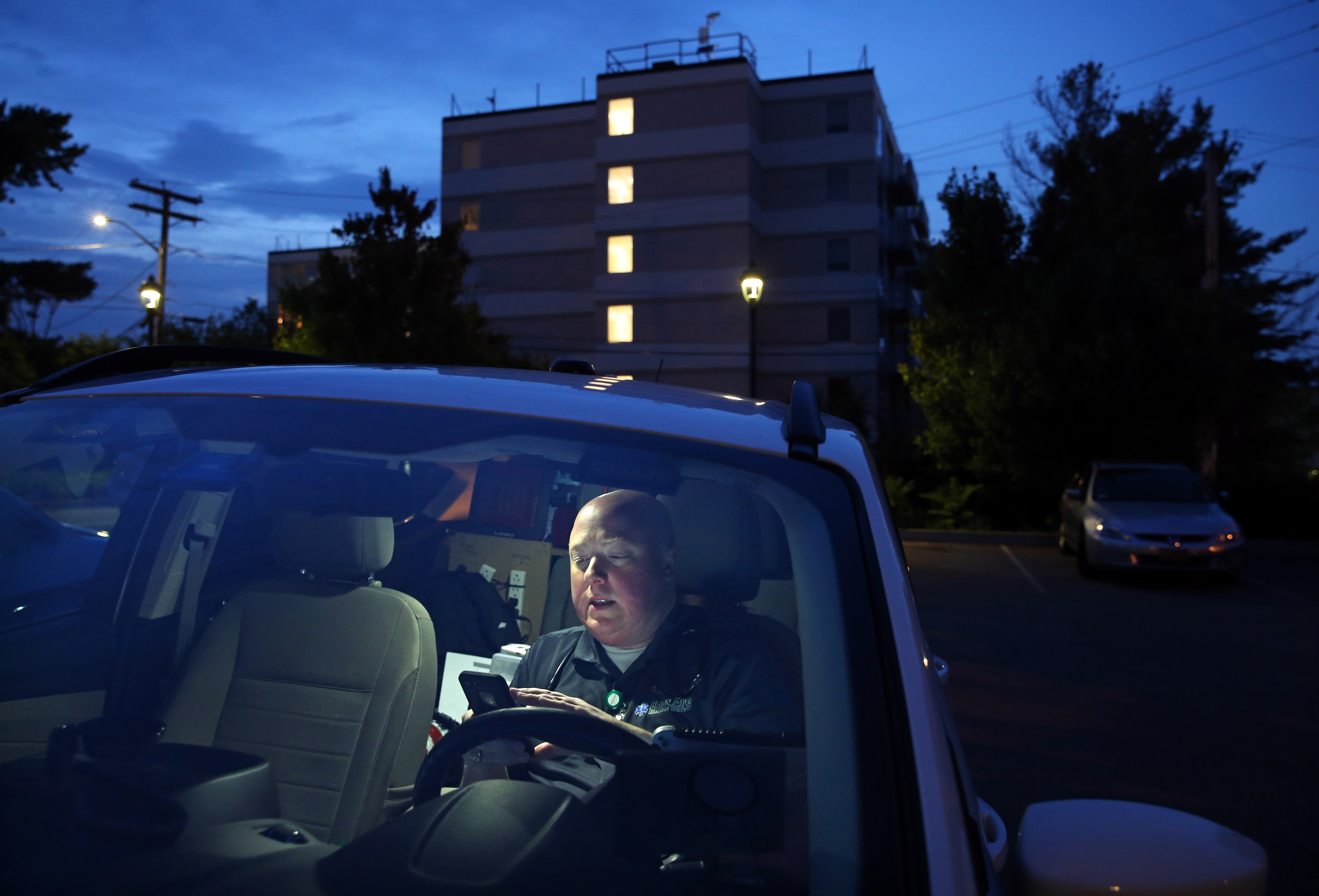 Paramedic Matthew Michaud of EasCare Ambulance Service took part in a conference call with a doctor and nurse during a home visit with Jamal Lee.