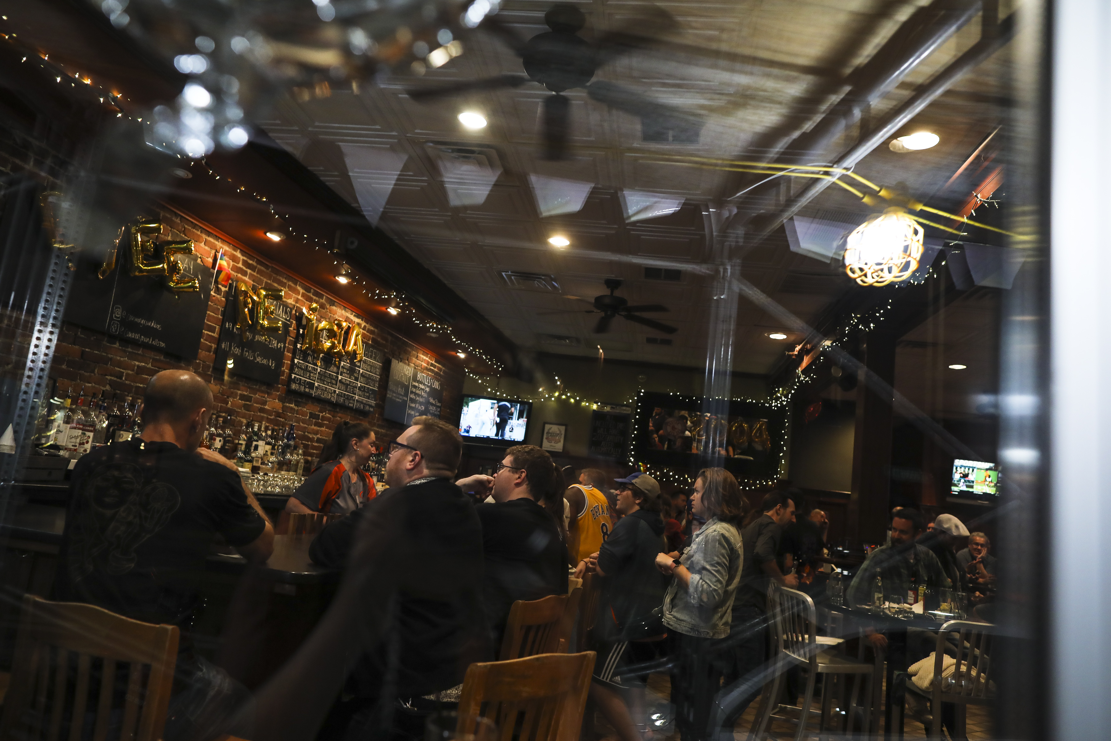 Bar-goers enjoyed their drinks at the bar Sunday, the final night that Common Ground in Allston would be open.