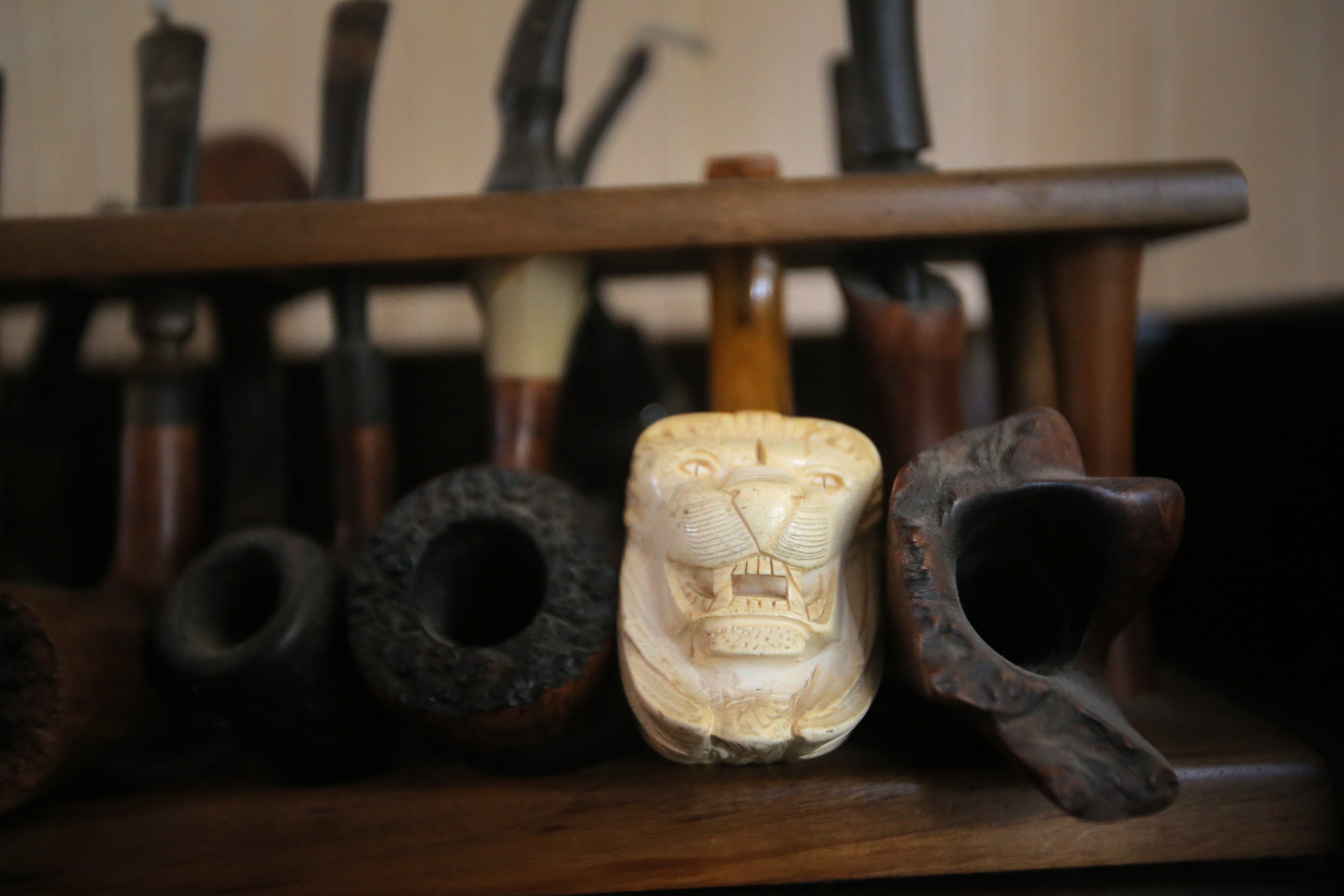 Among the small items decorating his workspace are several tobacco pipes, which he no longer smokes.