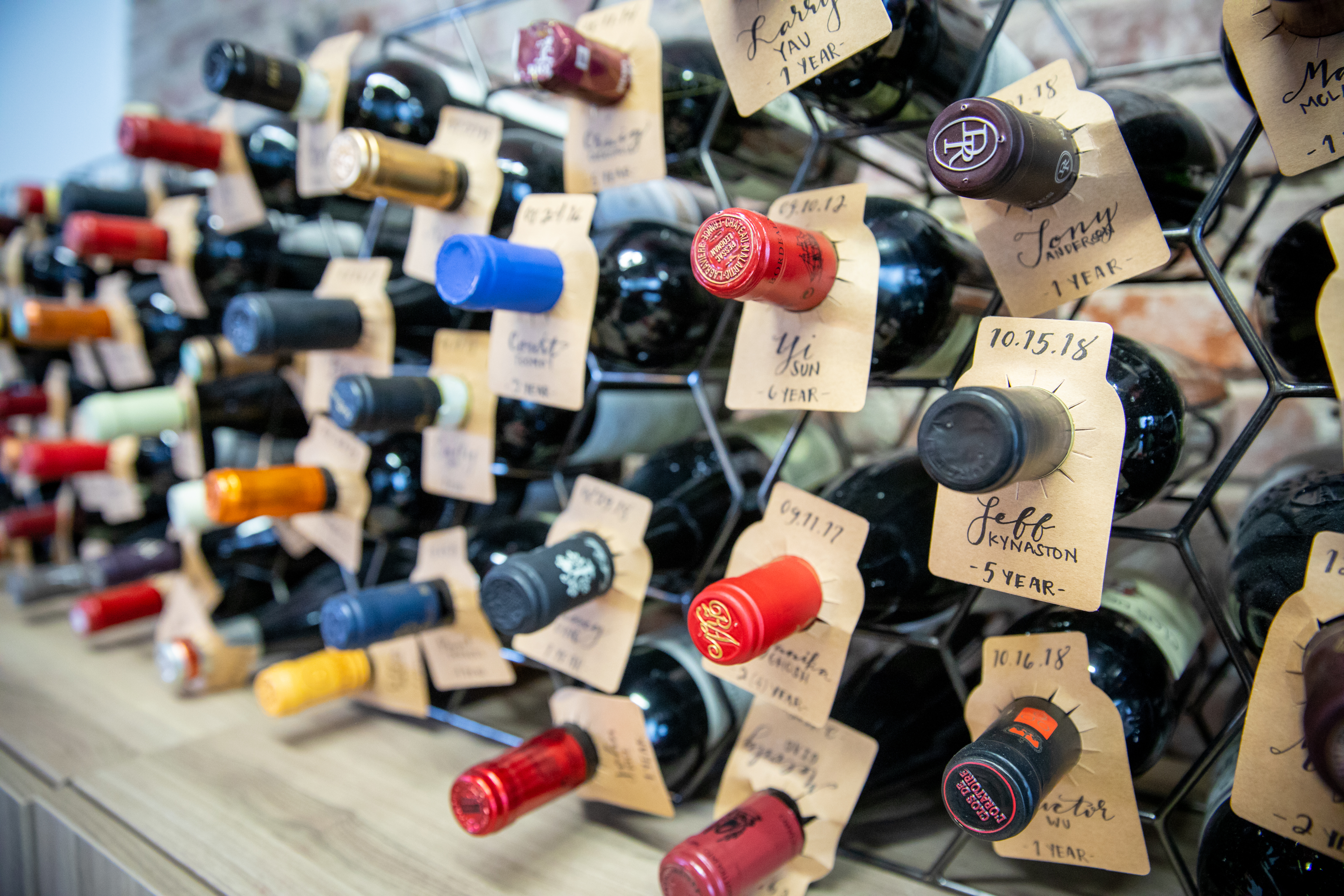 Bottles of wine aged on a shelf at Plastiq to commemorate work anniversaries.