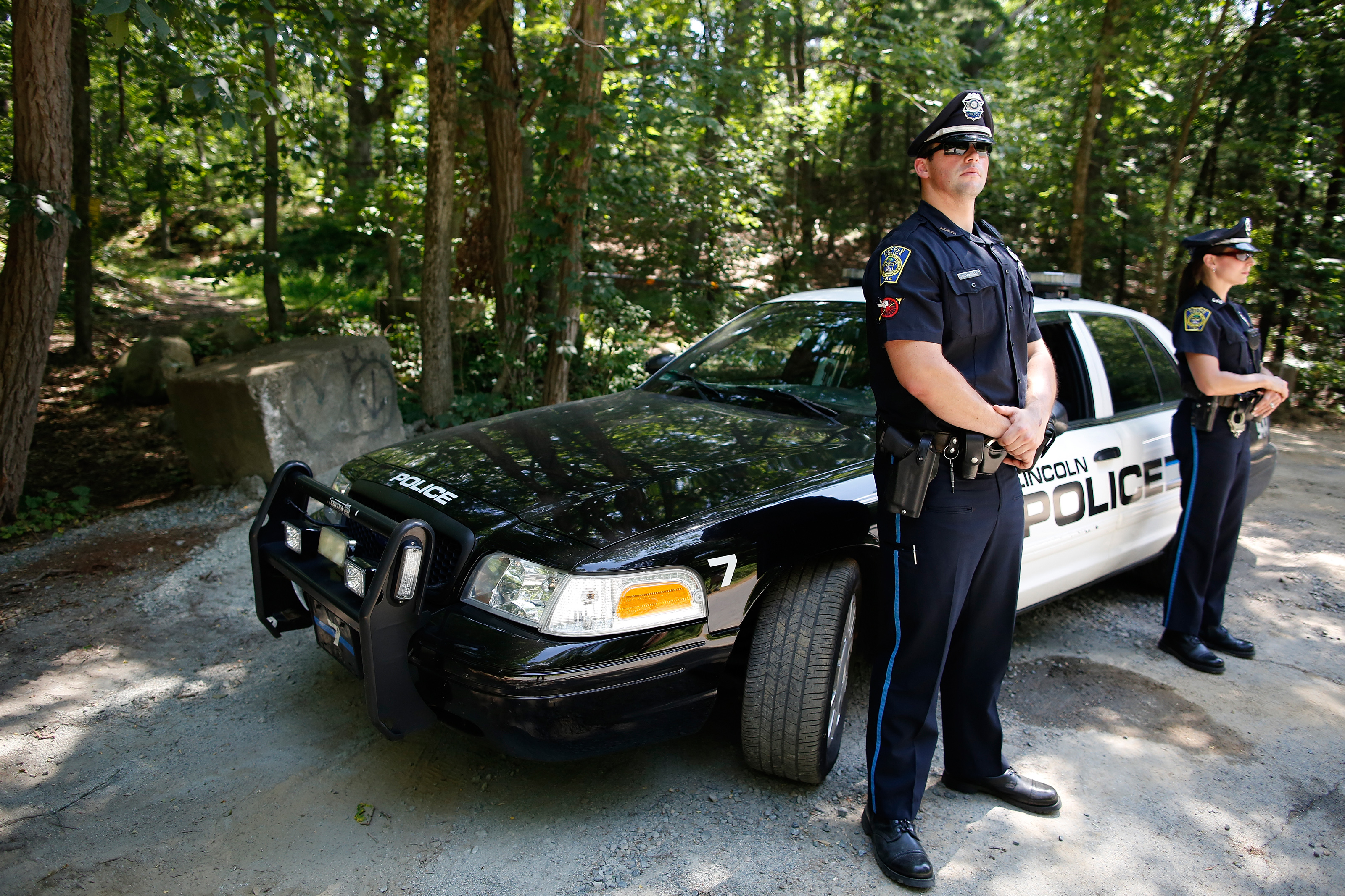Police officers stood in front of a path where the body of Stephen Rakes was found in Lincoln.