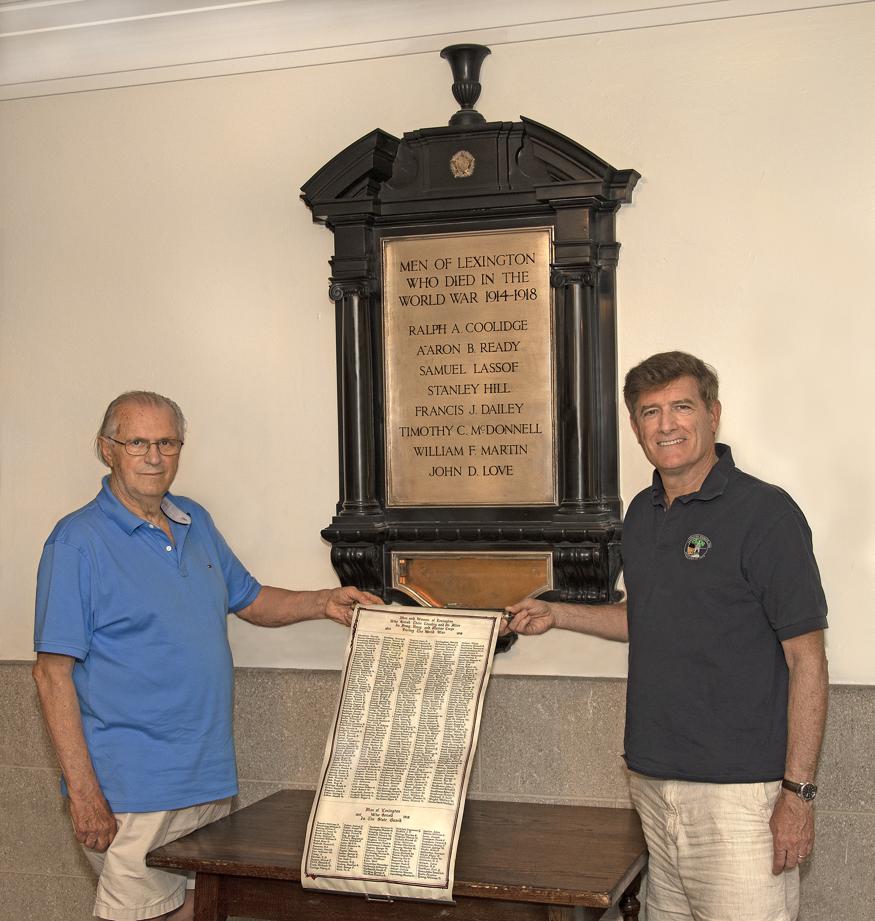 George Gamota (left) and Barry Cunha of the Lexington Historical Society with the scroll they found at Cary Memorial Hall.