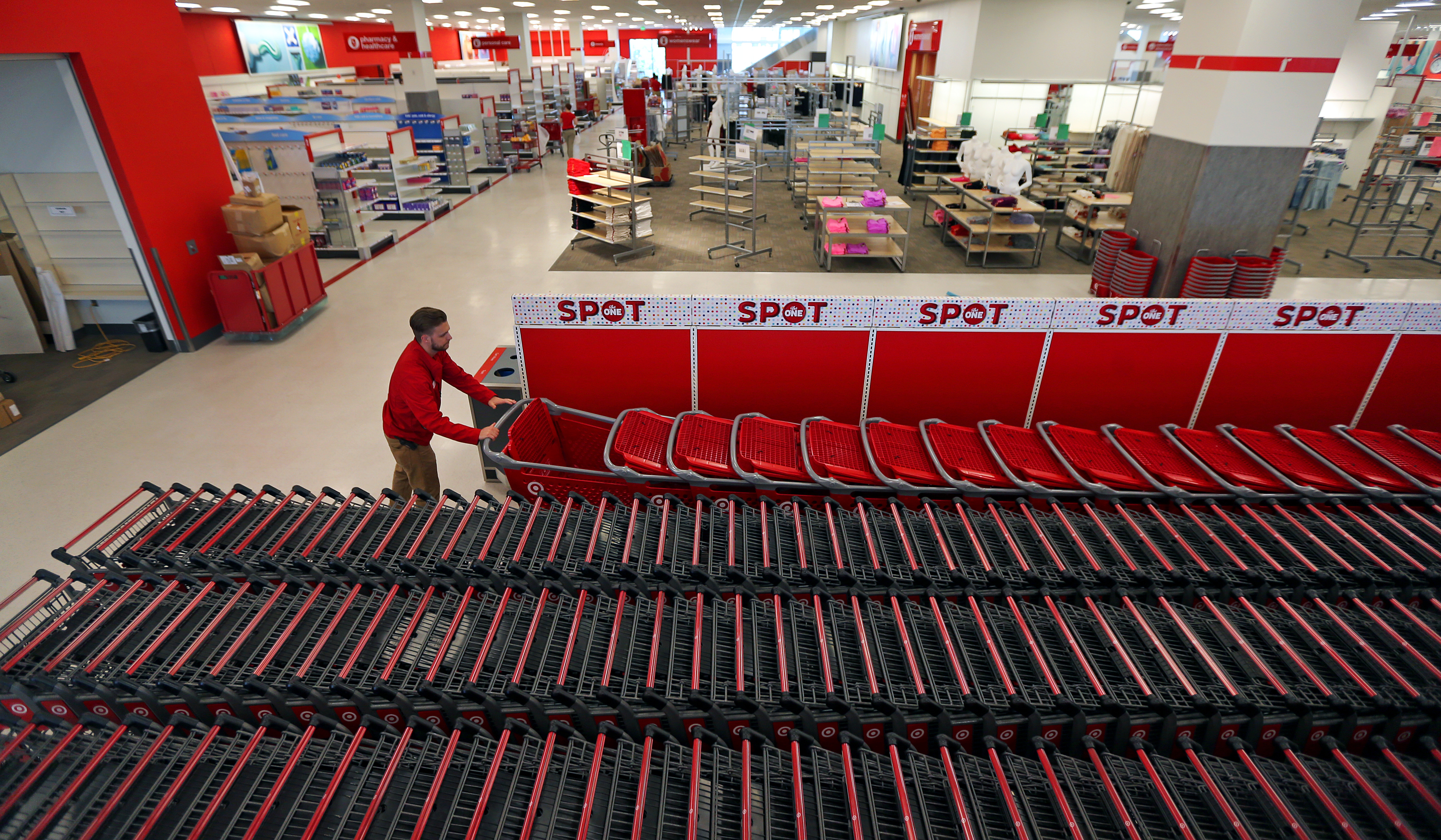 A CityTarget employee arranges shopping carts inside the new store.
