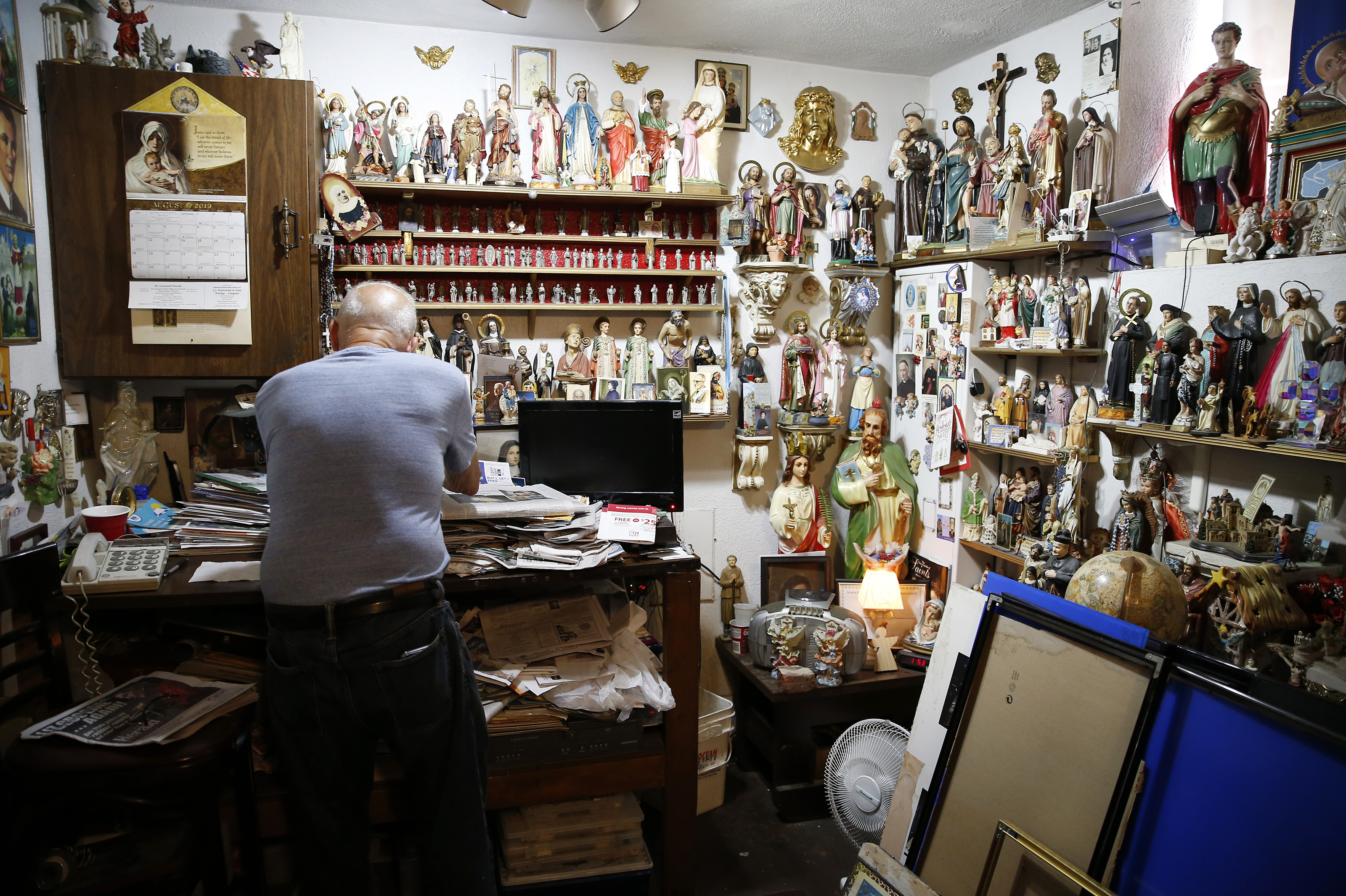 Peter Baldassari inside the workshop where he makes the collage pieces for All Saints Way. Baldassari, 75, knows where every saint is in the alley, because he put them there.