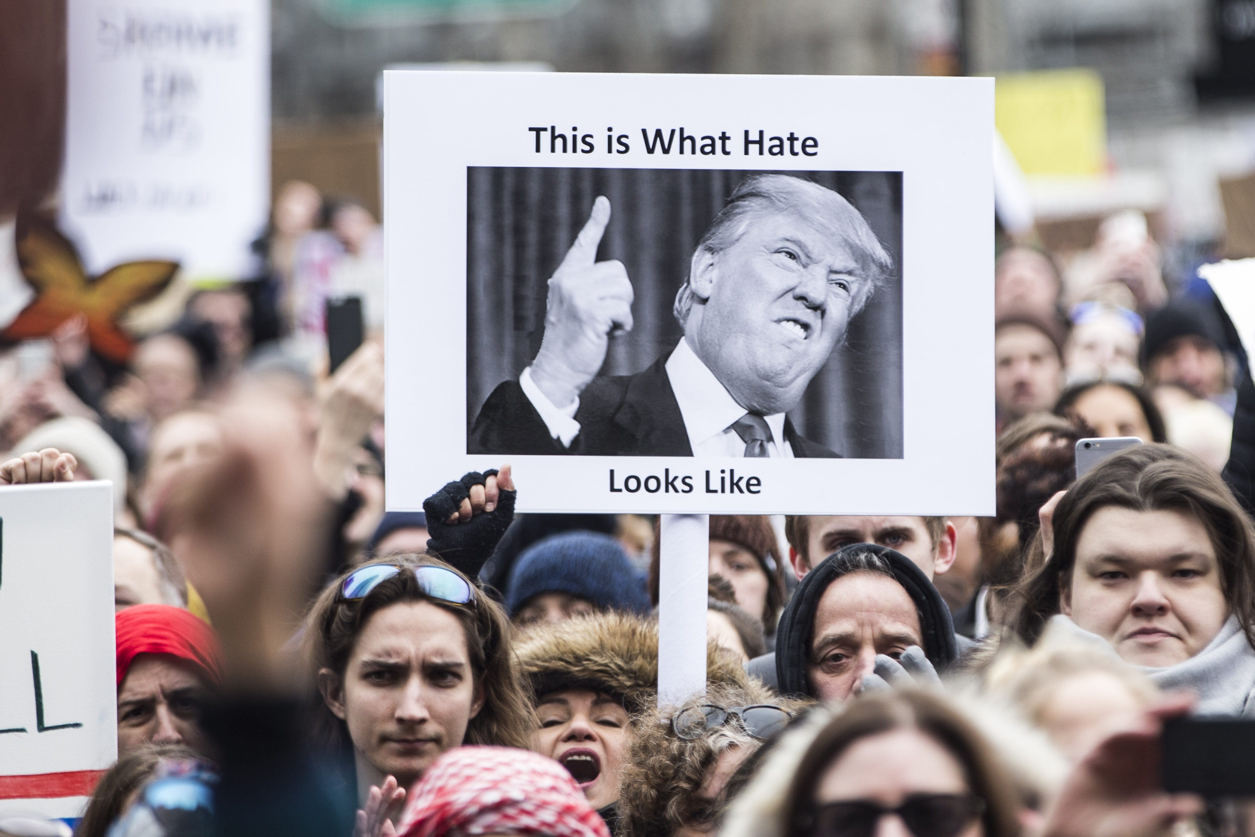 One protester held an anti-Trump sign in Copley Square, where thousands gathered on Sunday.