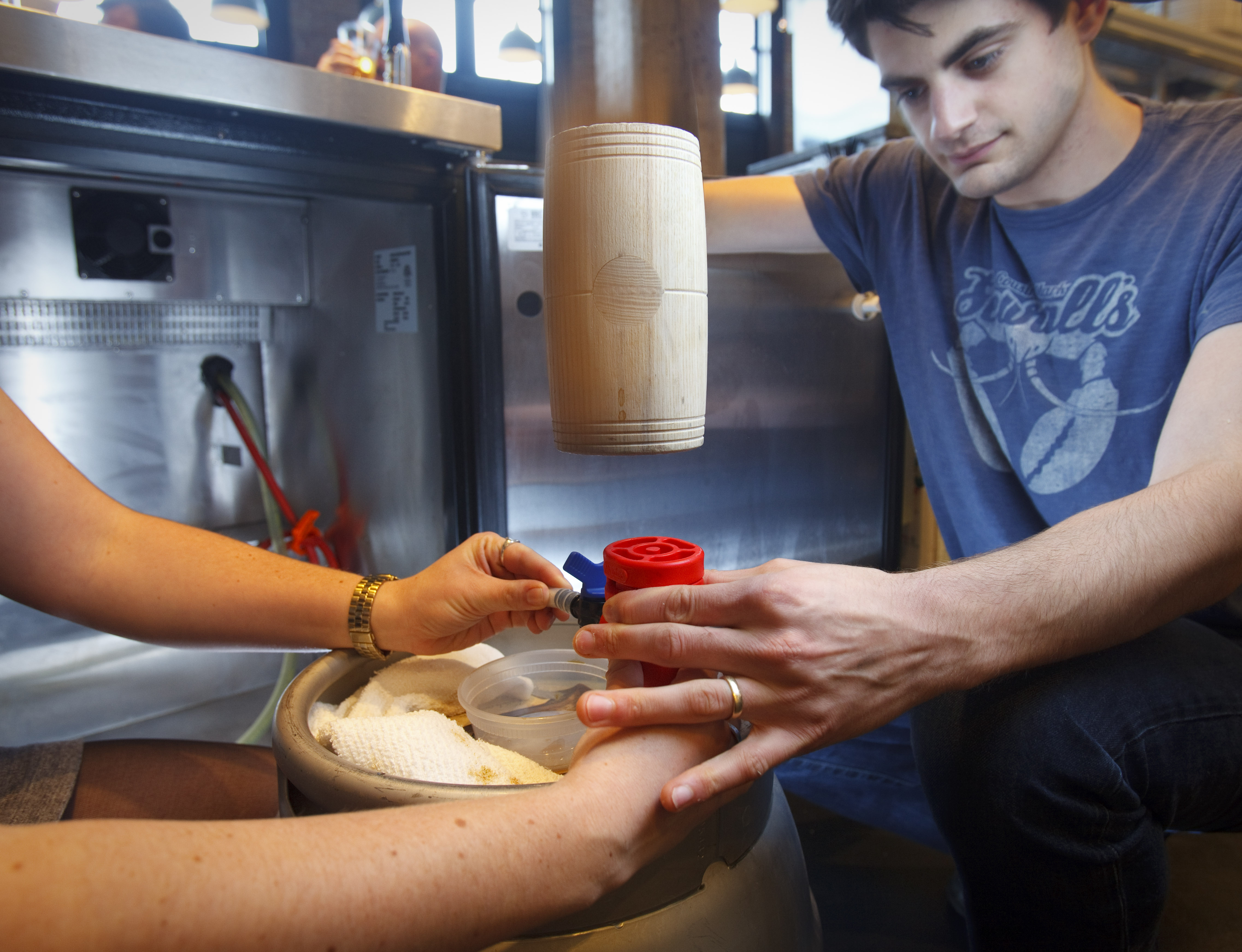 Alexander Kolb taps a cask of the coffee beer that Row 34 is serving from the Barrington-Trillium collaboration.