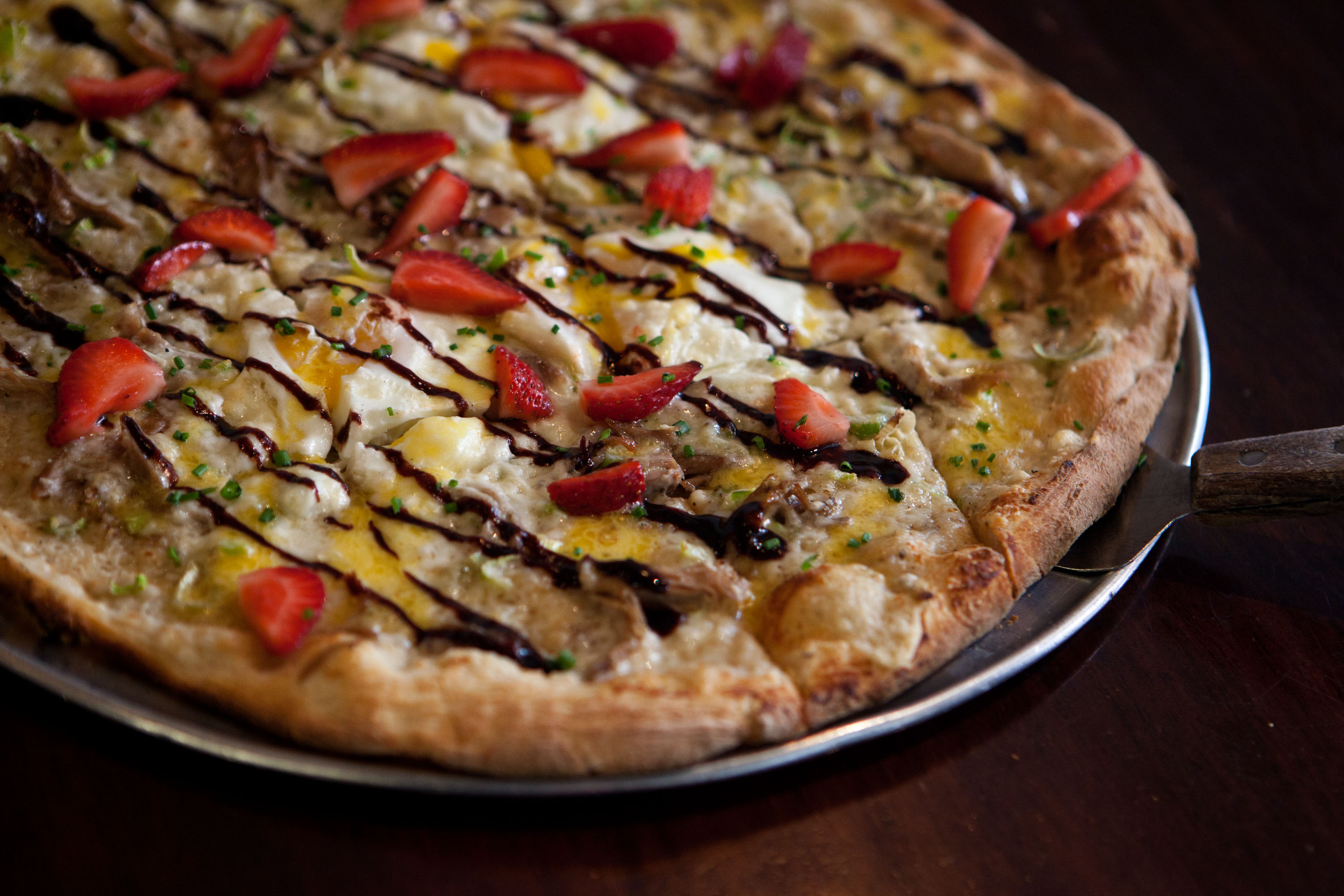 Rail Trail’s duck beni flatbread, made with sunny-side eggs, leeks, and strawberries.