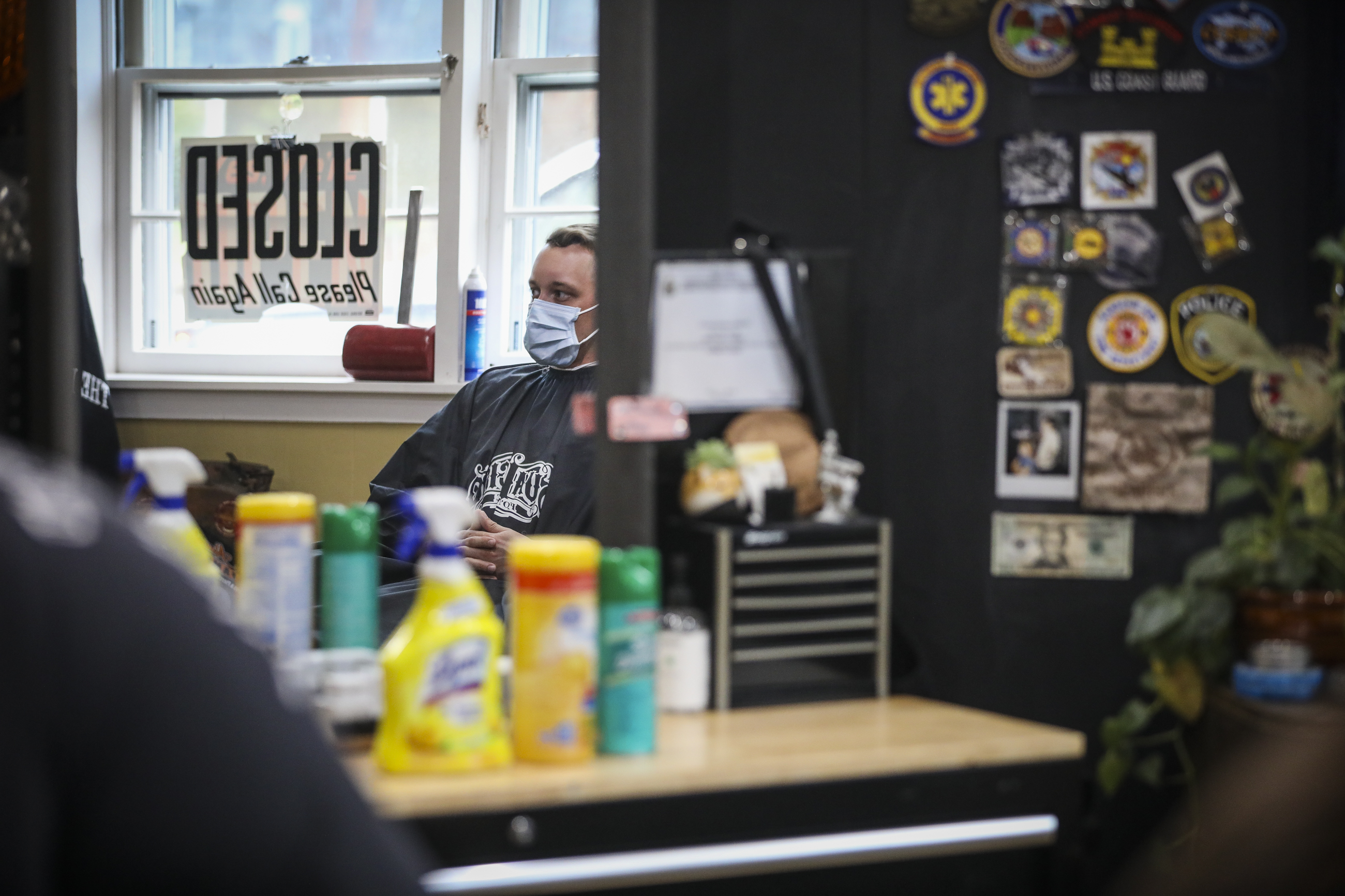 Cleaning products were lined up across a hair cutting station as Ethan Lee had his hair cut at the Rusty Razor on Friday.