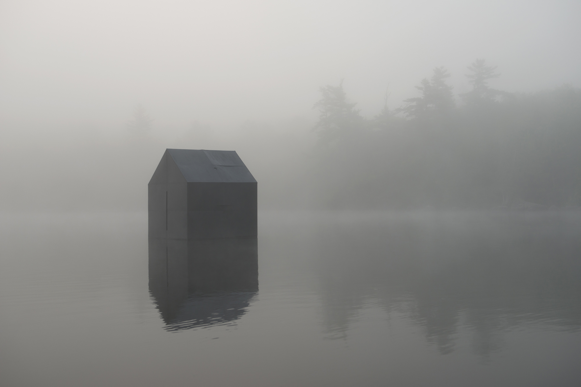 William Lamson’s photograph of his reproduction of Thoreau’s cabin, which he set afloat.
