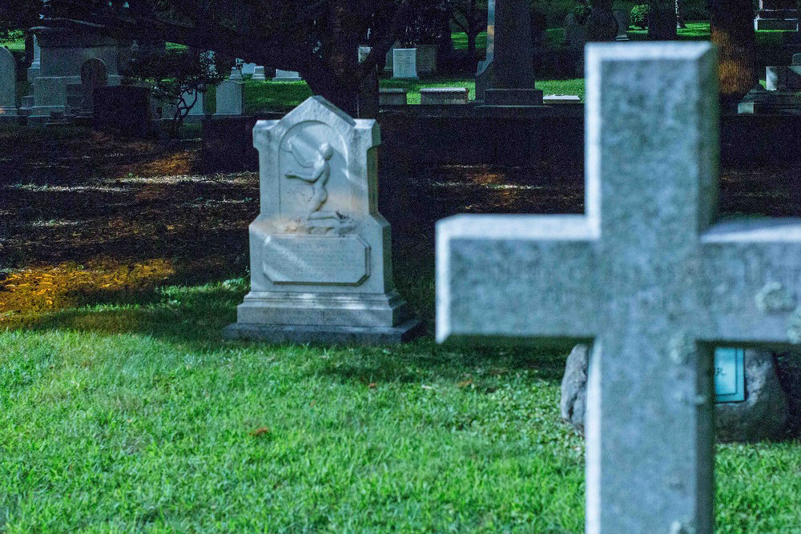 The memorial for Peter Byus (left), an escaped slave from Virginia who worked as a tailor on Beacon Hill, glows in the moonlight.