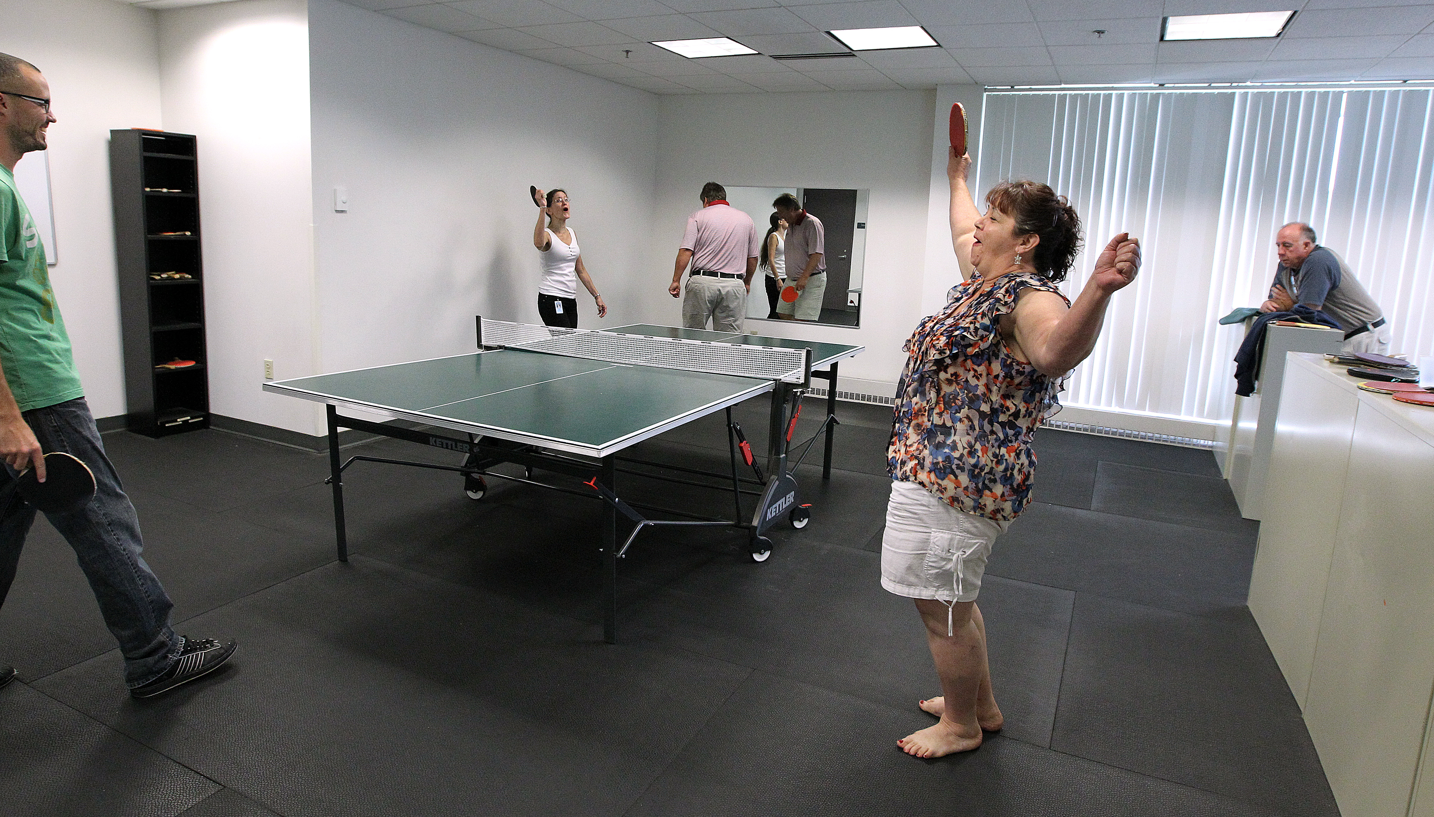 Customer service representative Angela Colon (right) and her partner beat CEO Ray Hendrickson and copywriter Pegge Bochynski in Christian Book Distributors’ annual Ping-Pong tournament.