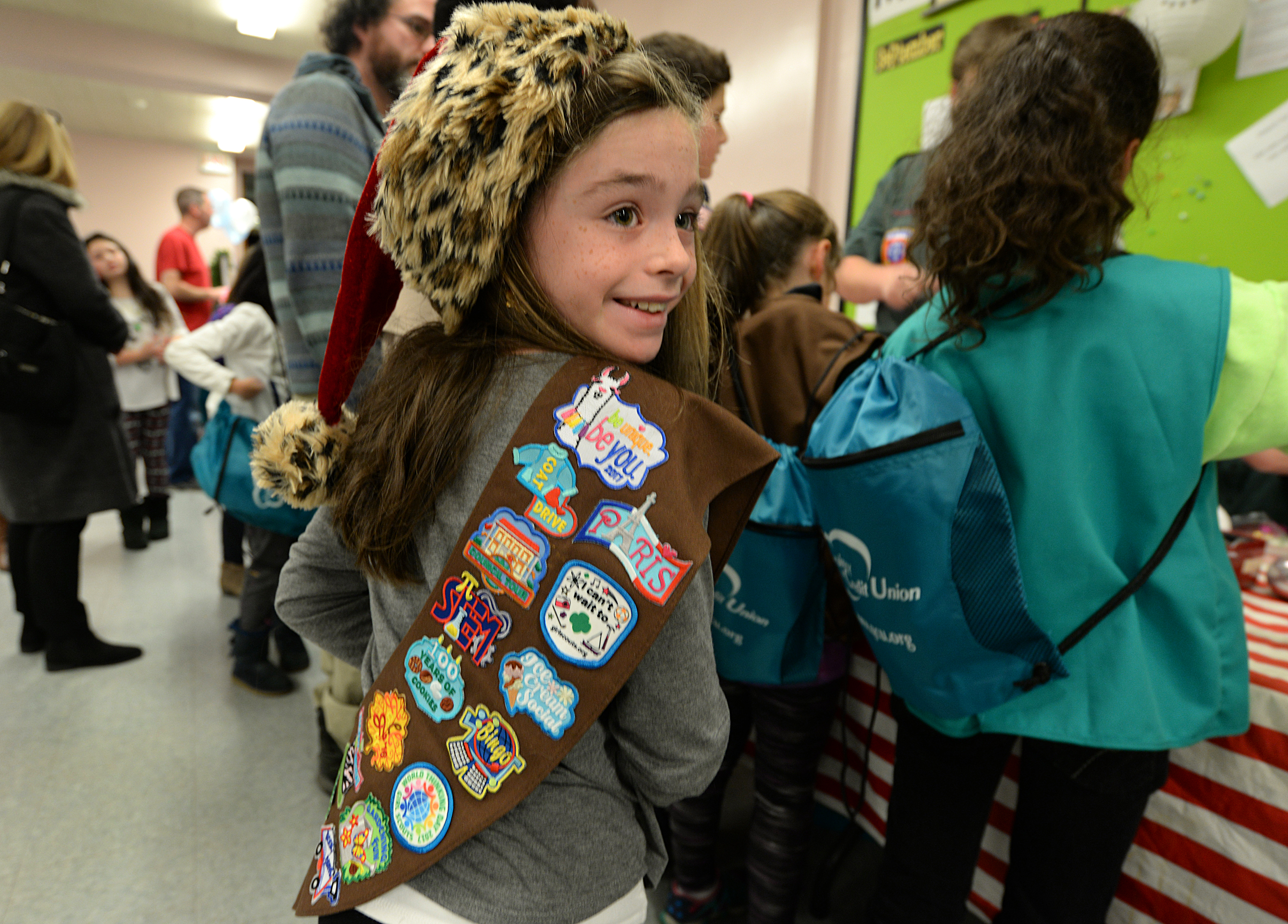 Mackenzie Ilacqua, 8, with an array of badges on her Brownie sash during the Holiday Craft Fair at Wollaston Congregational Church in Quincy.