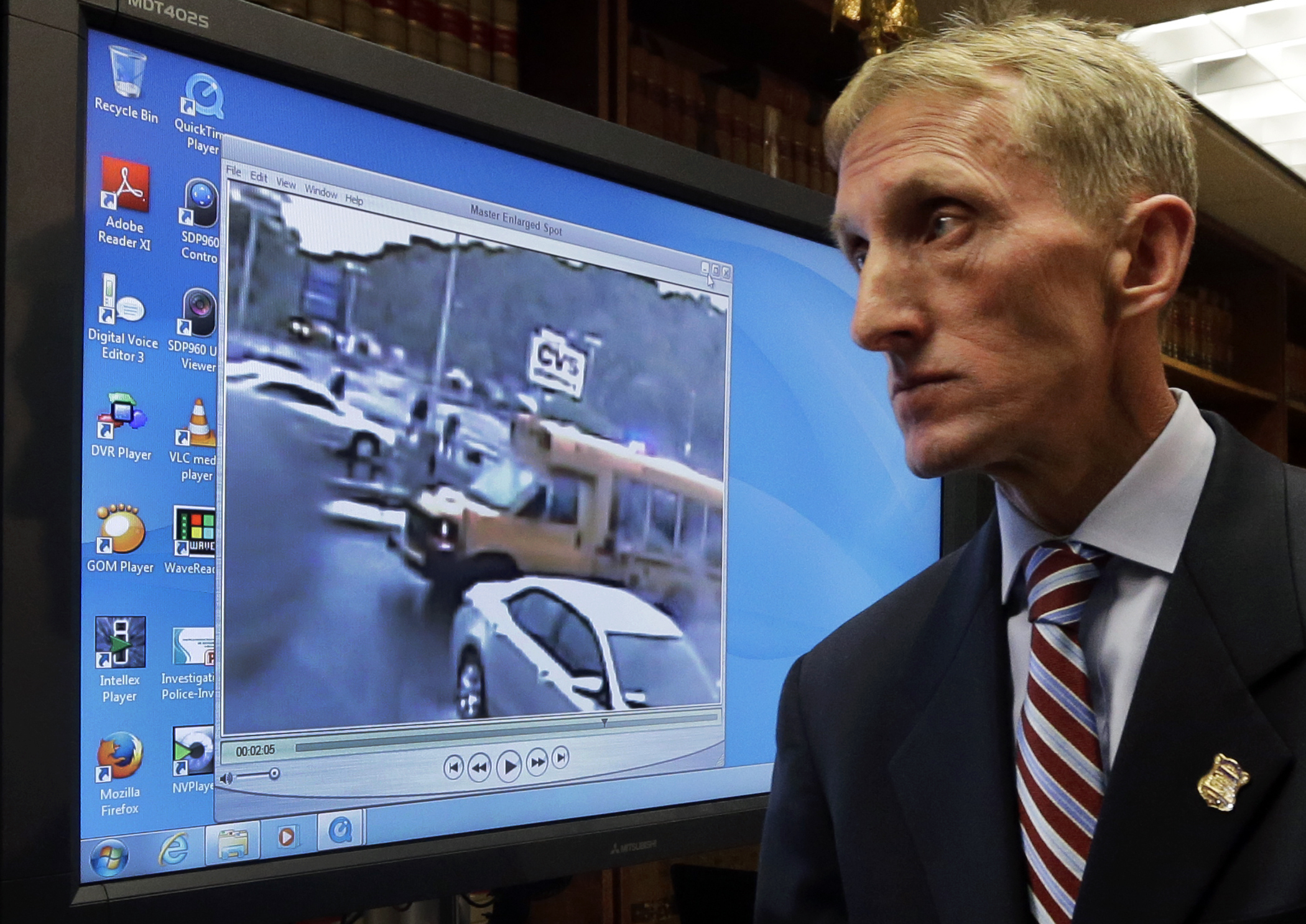 Boston Police Commissioner William Evans walked past a monitor June 8 after releasing a surveillance video that police say shows the fatal shooting of a Boston man suspected of plotting to kill police officers.