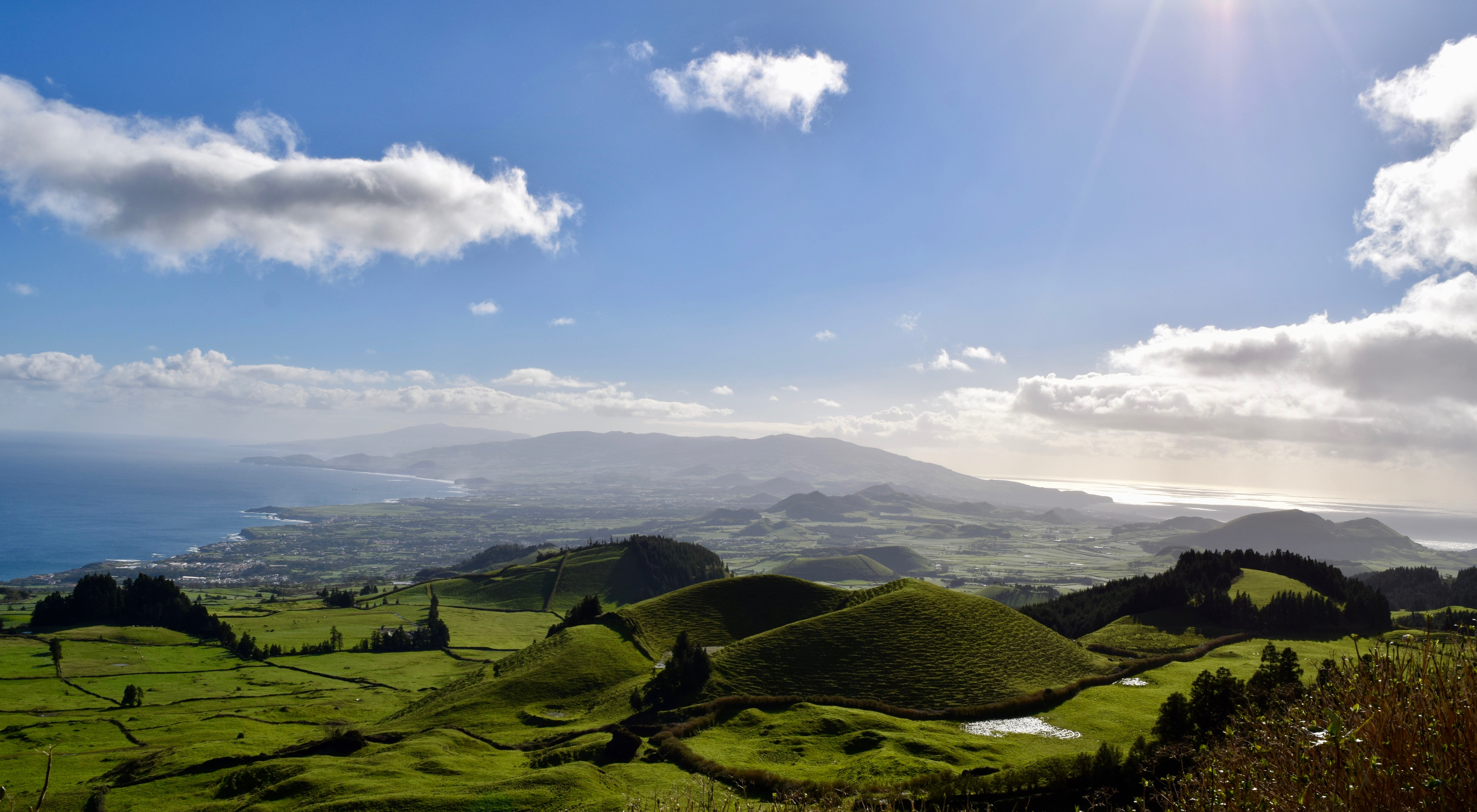 The rolling hills lead to the dramatic coastline on the island of São Miguel in the Azores