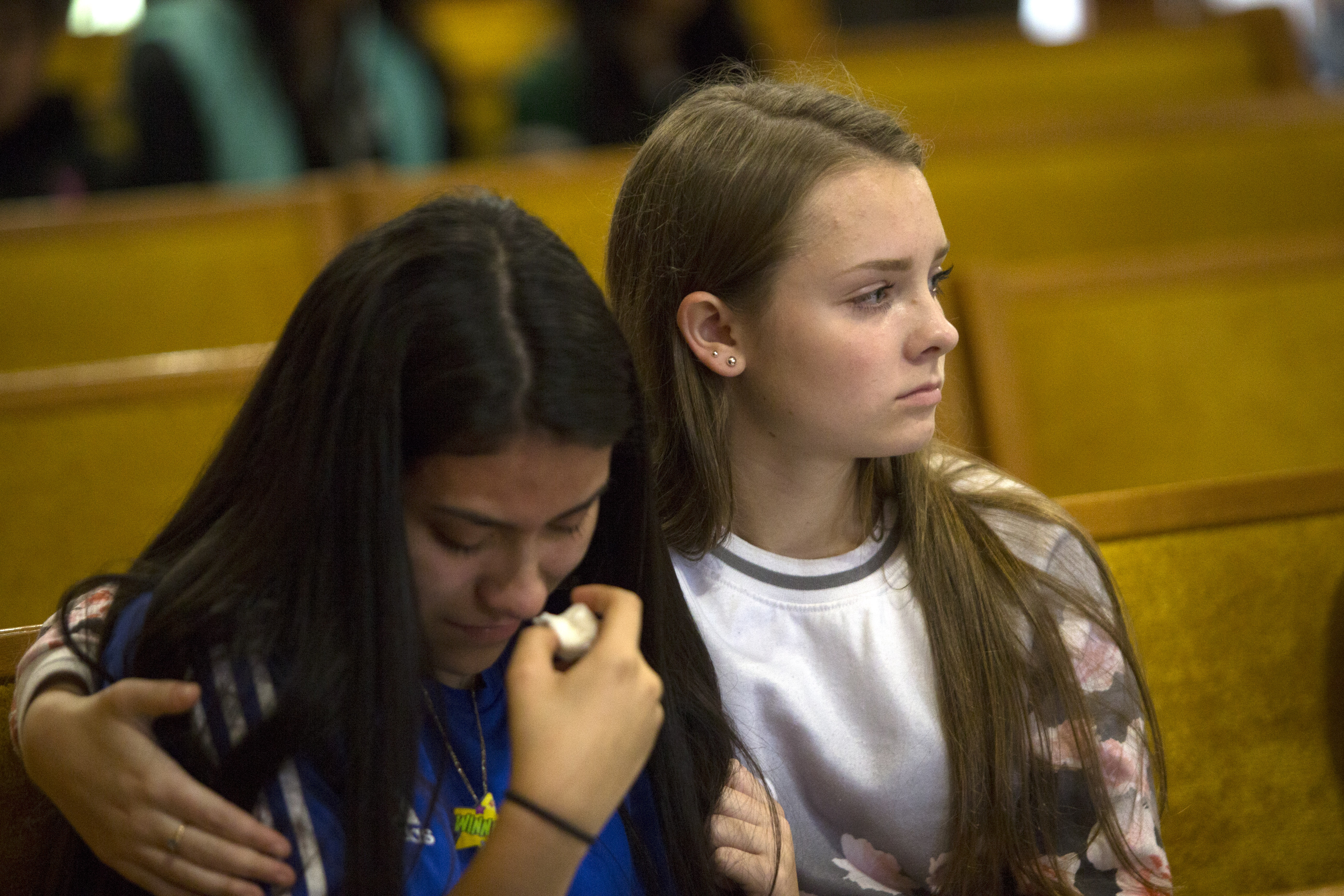 Selena Orozco (left) and Rachel March, both 15, attended a vigil Saturday for the shooting victims at Central United Methodist Church Sedro-Woolley, Wash.