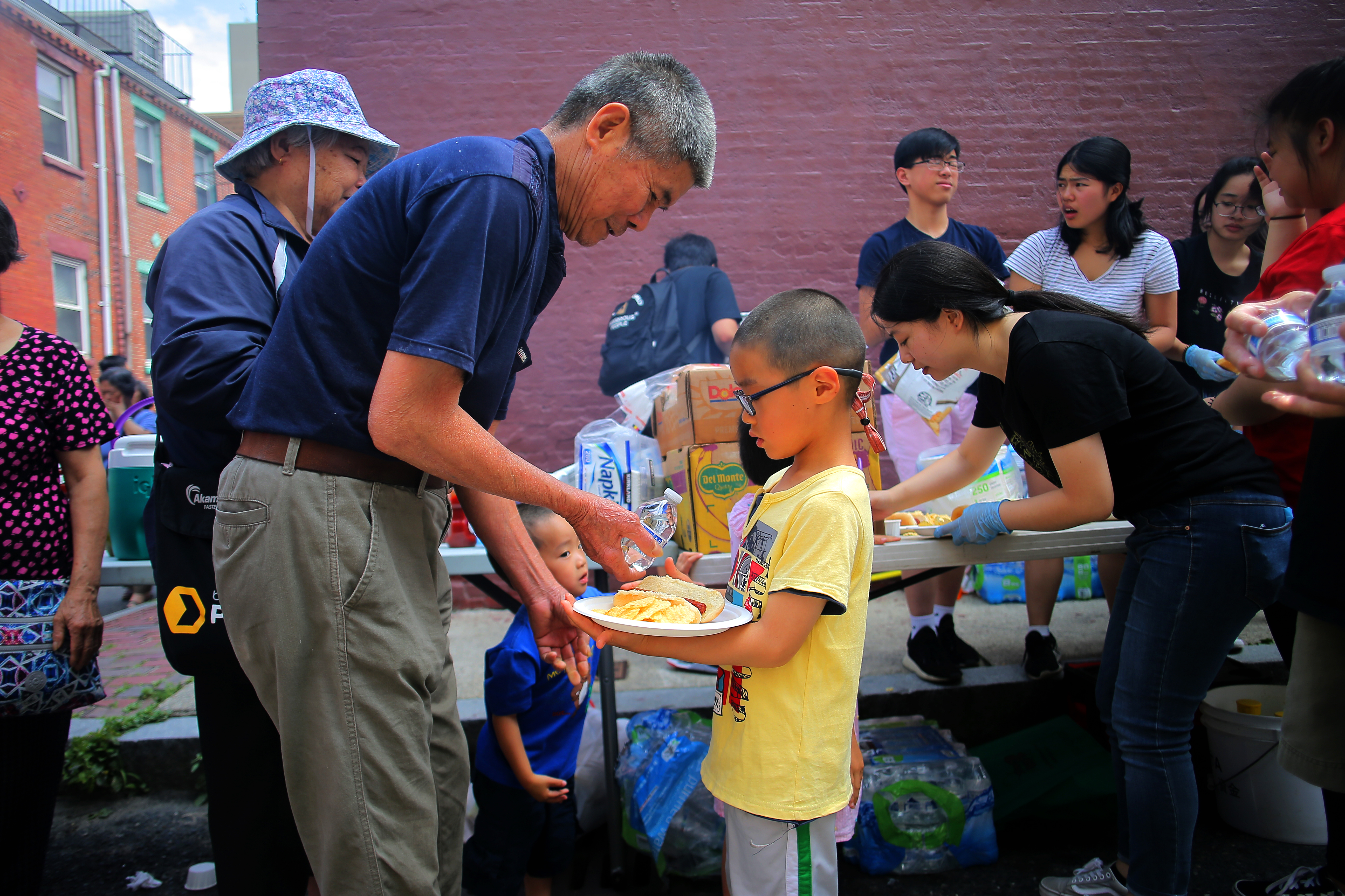 Residents made sure everyone was fed at the Stabilize Chinatown Block Party at the corner of Maple Place and Johnny Court in Chinatown.