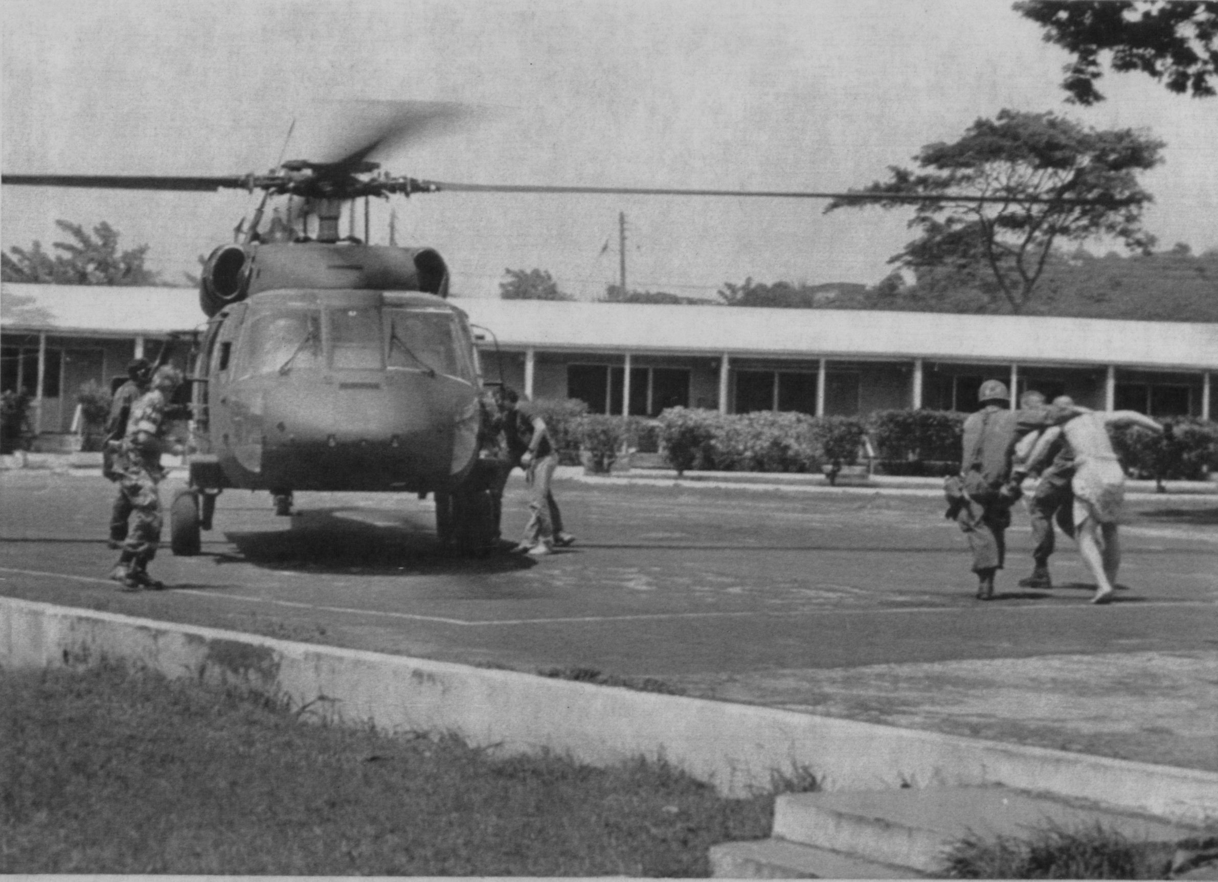 US Army medical personnel helped a wounded soldier to a helicopter at St George's University School of Medicine in Grenada.