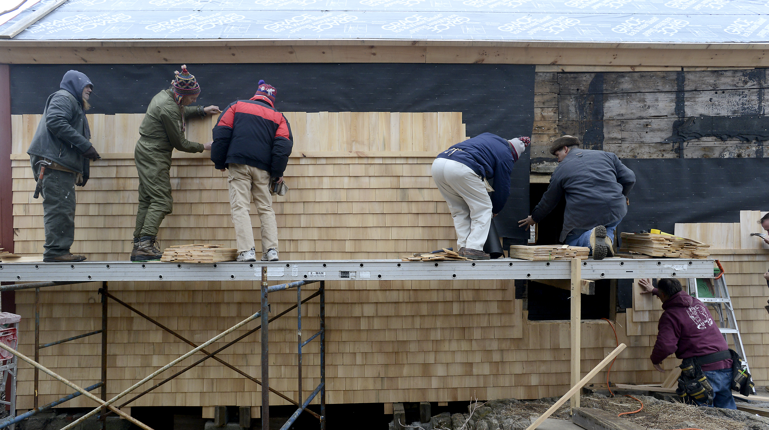 Volunteers work on restoration of fish shack at Lane's Cove in the Lanesville section of Gloucester, Mass. Feb. 23, 2013.