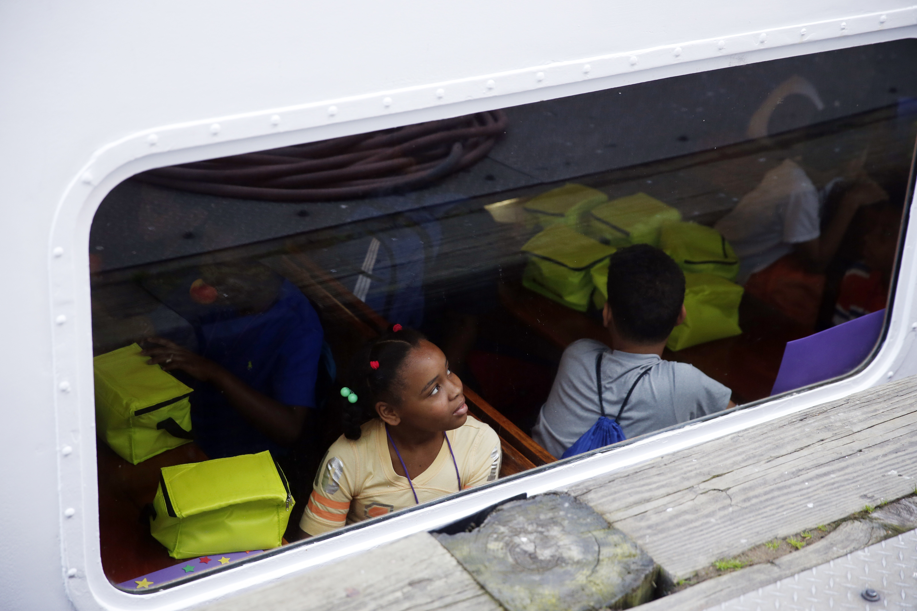 Angelica Jones looked up at other campers boarding the ferry as they made their first trip to Long Island this year.