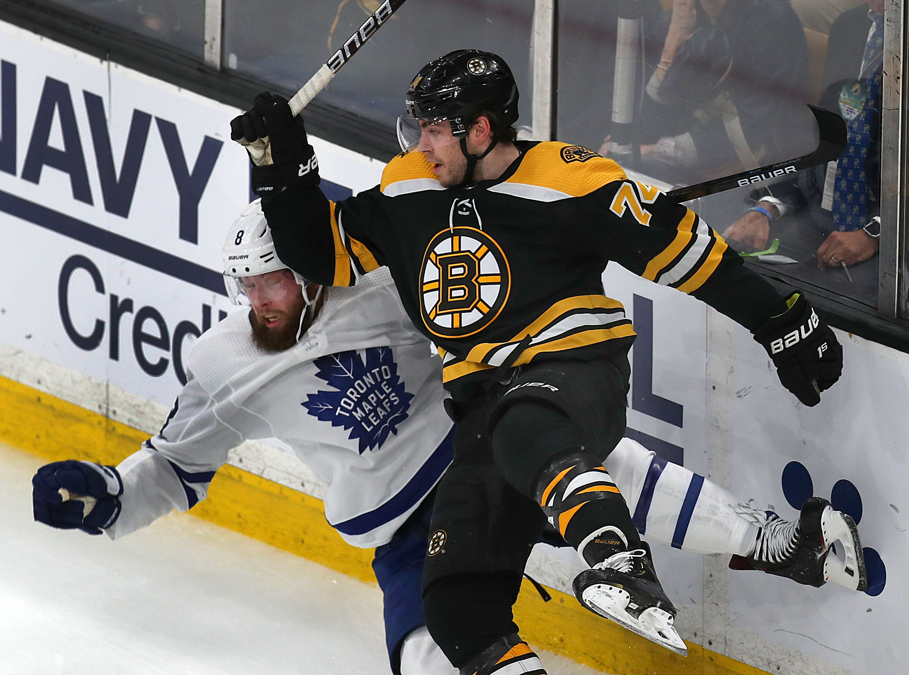Bruins winger Jake DeBrusk collided with Maple Leafs defenseman Jake Muzzin along the boards.