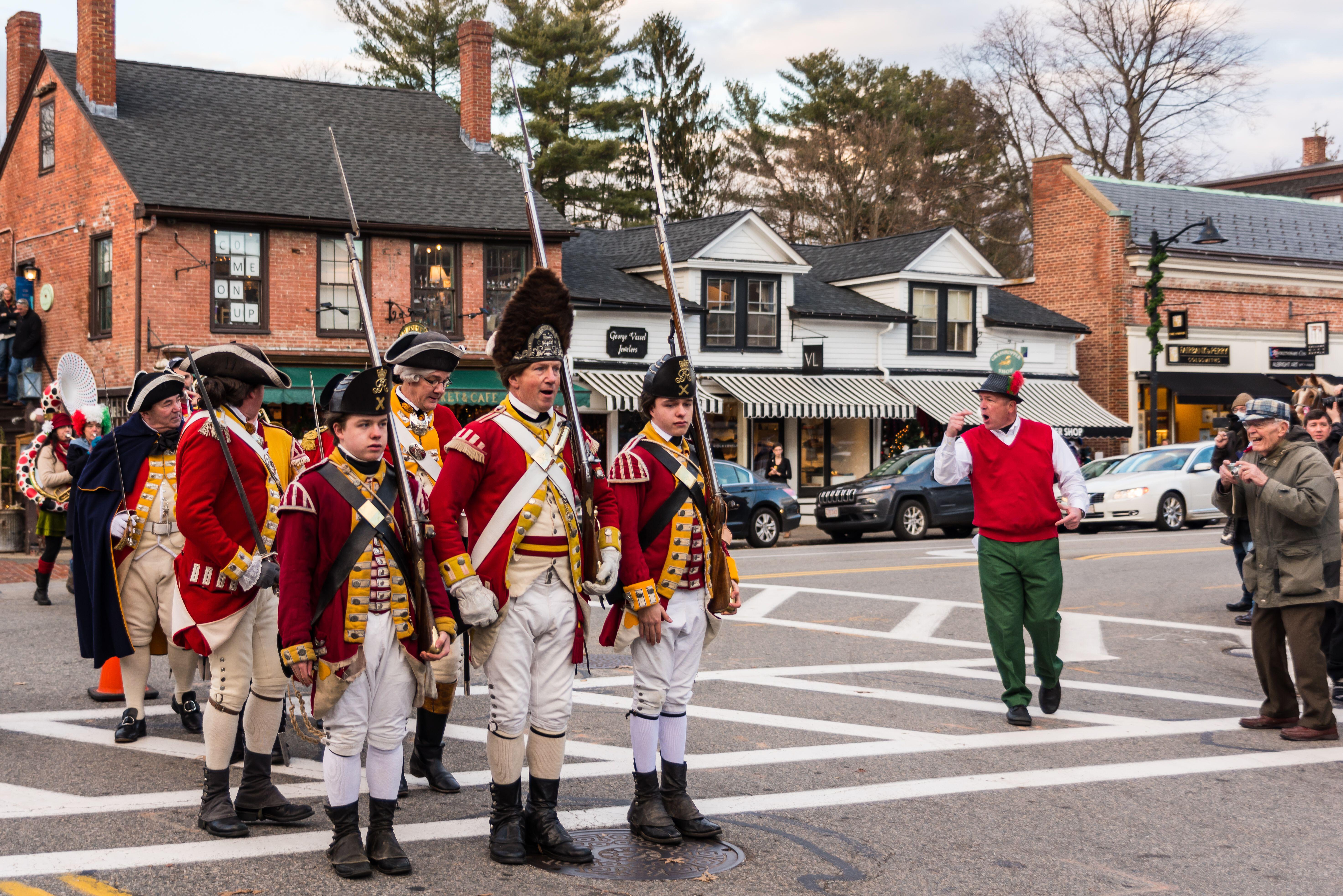 Historical reenactors stand at attention on Walden Street in Concord.
