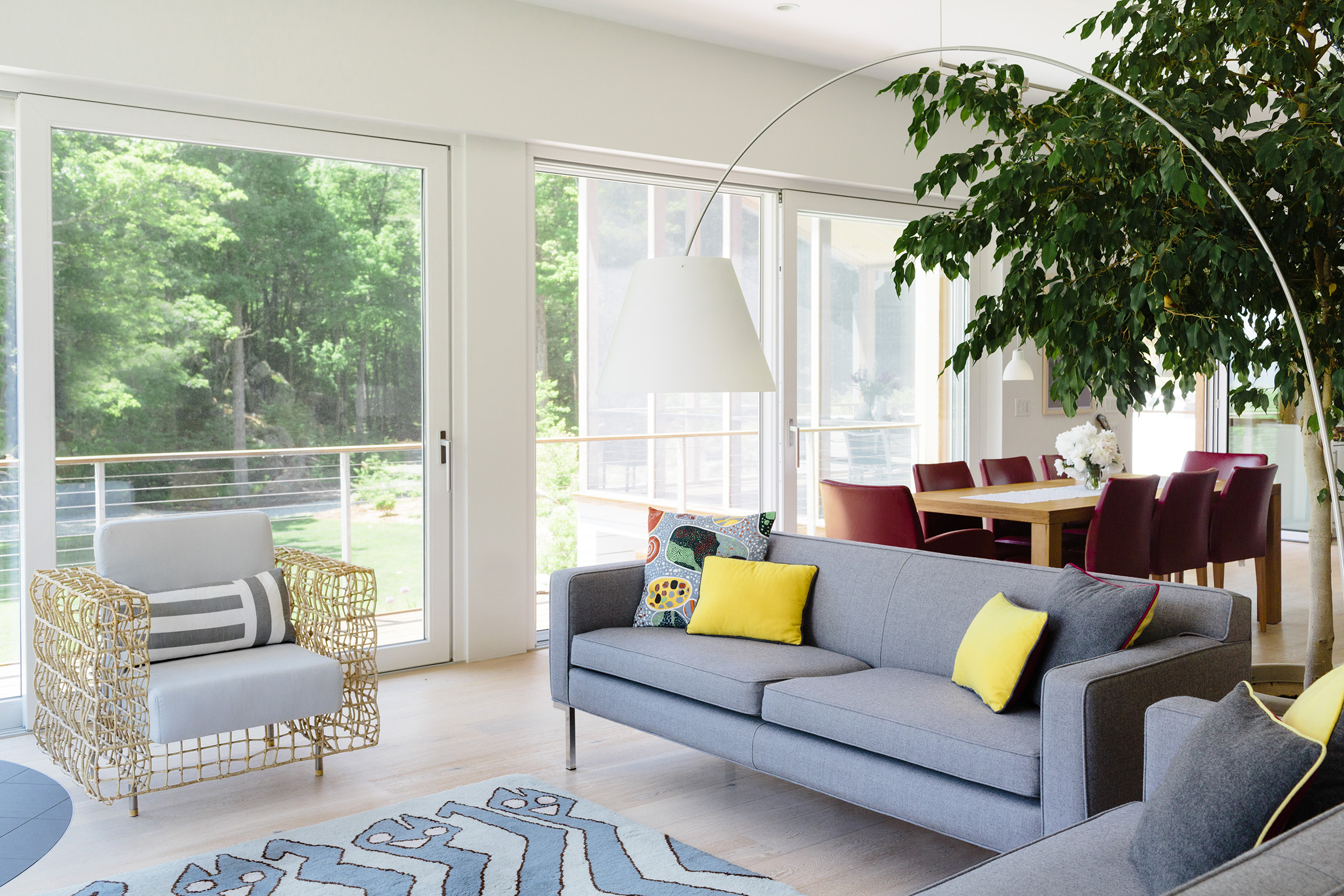 Architect Mary Yun designed a steel-cable balcony railing that leaves the lush views from the living area unobscured. The distinctive armchair, a recycling-store find, is from Kenneth Cobonpue’s Yin & Yang collection.