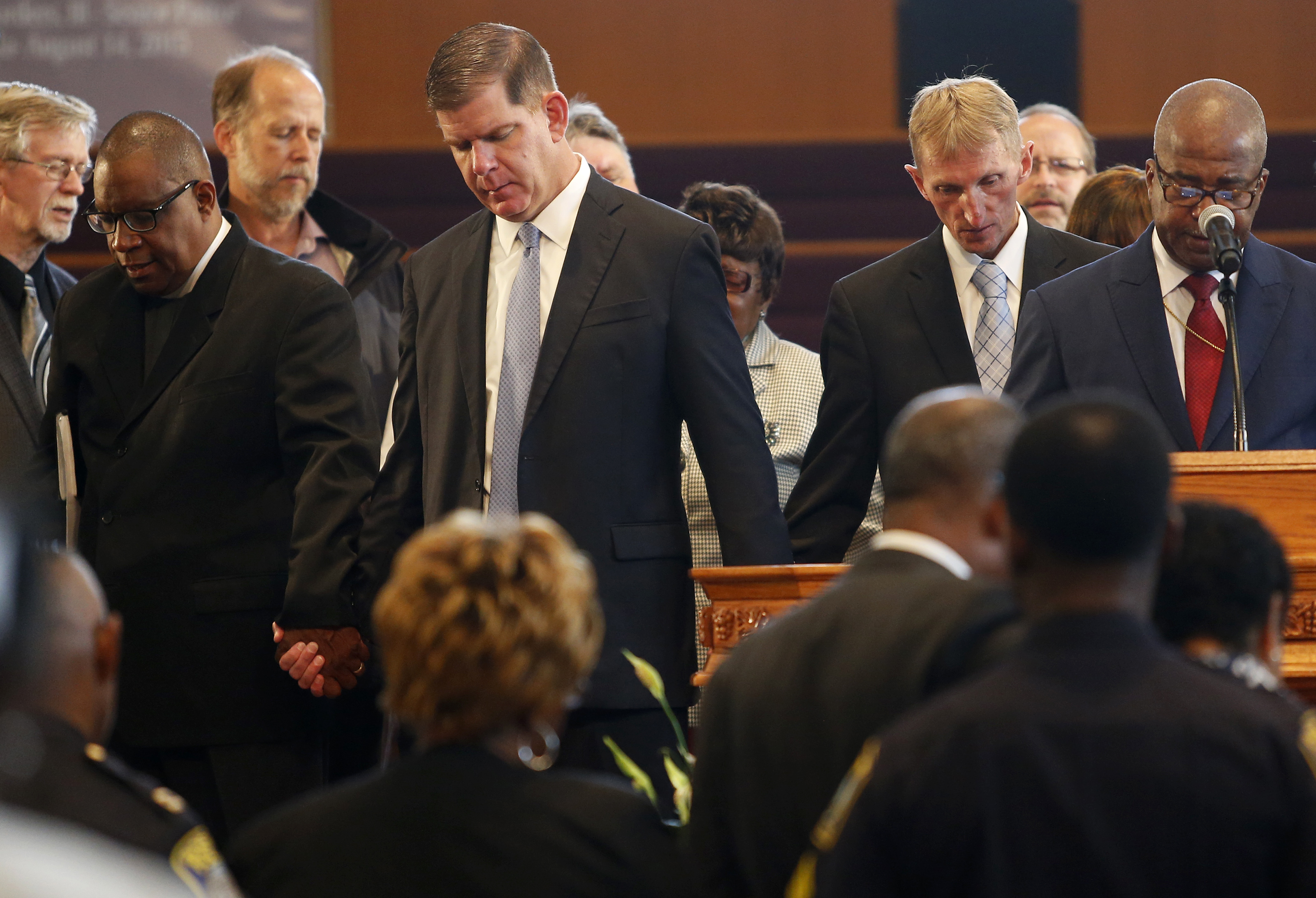 Mayor Marty Walsh and Police Commissioner William Evans joined hands in prayer at Morningstar Baptist Church.