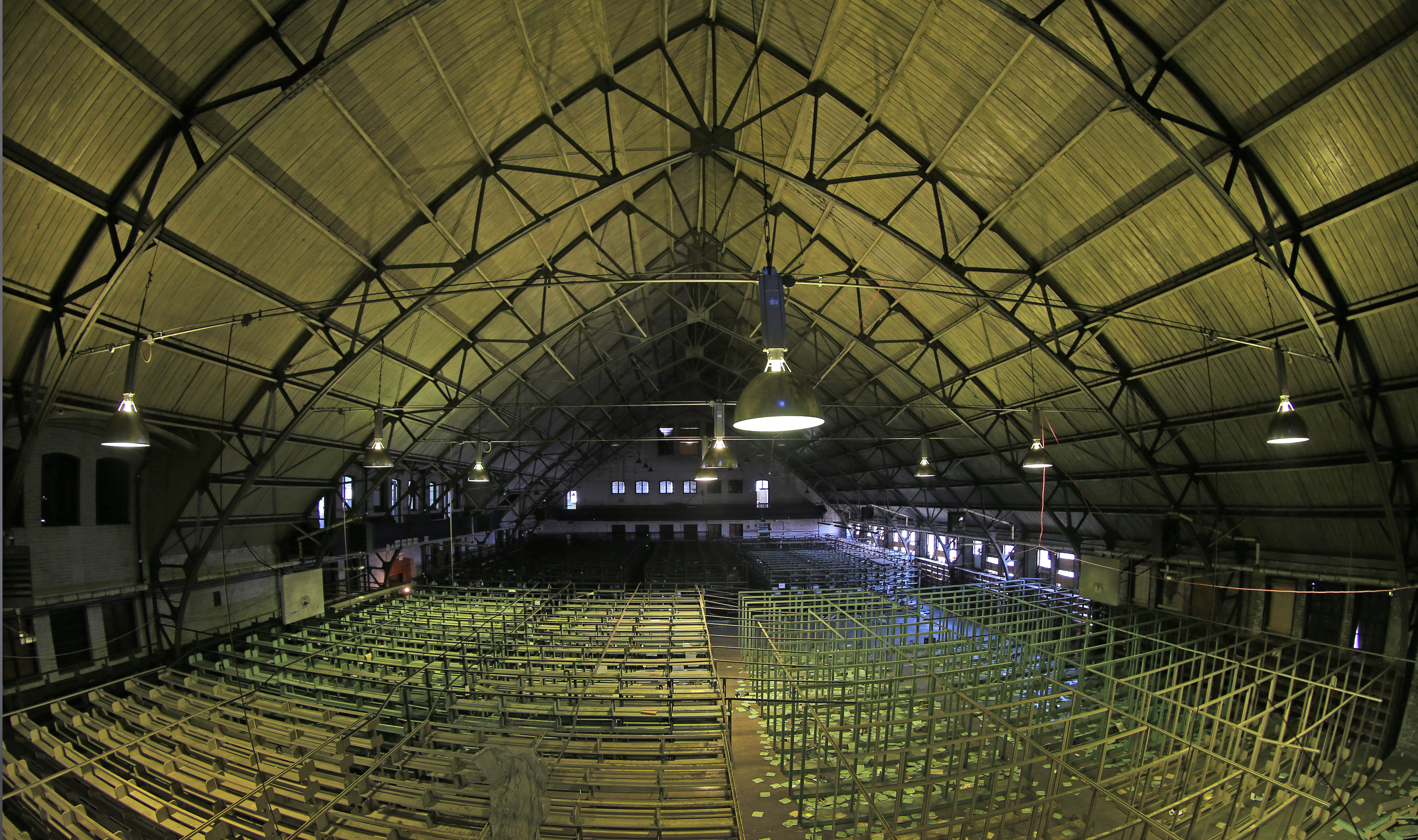 The city seeks proposals for the Charlestown Armory on Bunker Hill Street. An inside view shows shelves for the library annex.