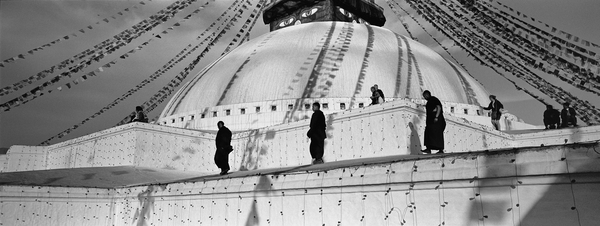 “Monks and pilgrims on the Boudhanath Stupa, Kathmandu.”