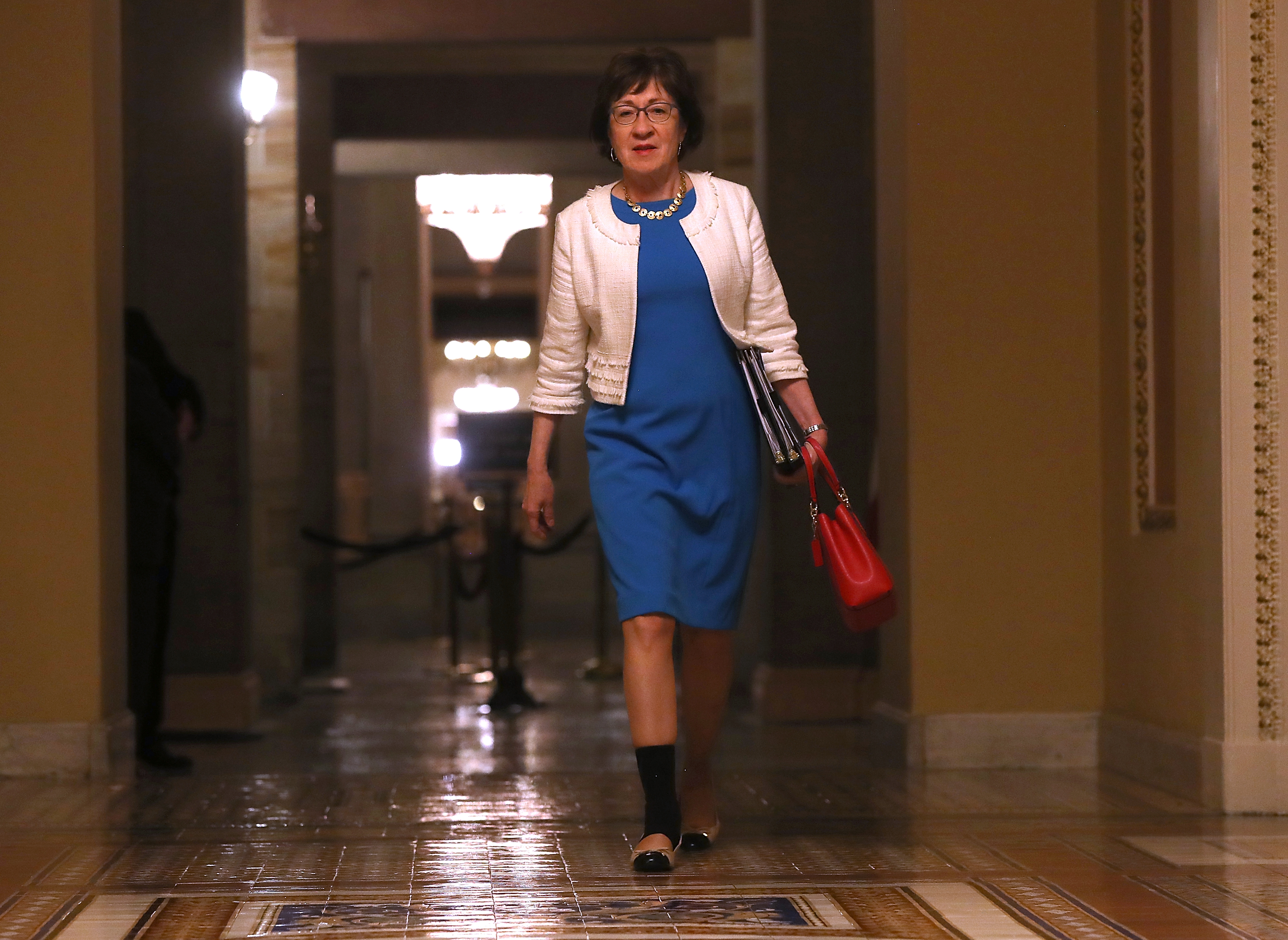 Senator Susan Collins walked to the Senate chamber.