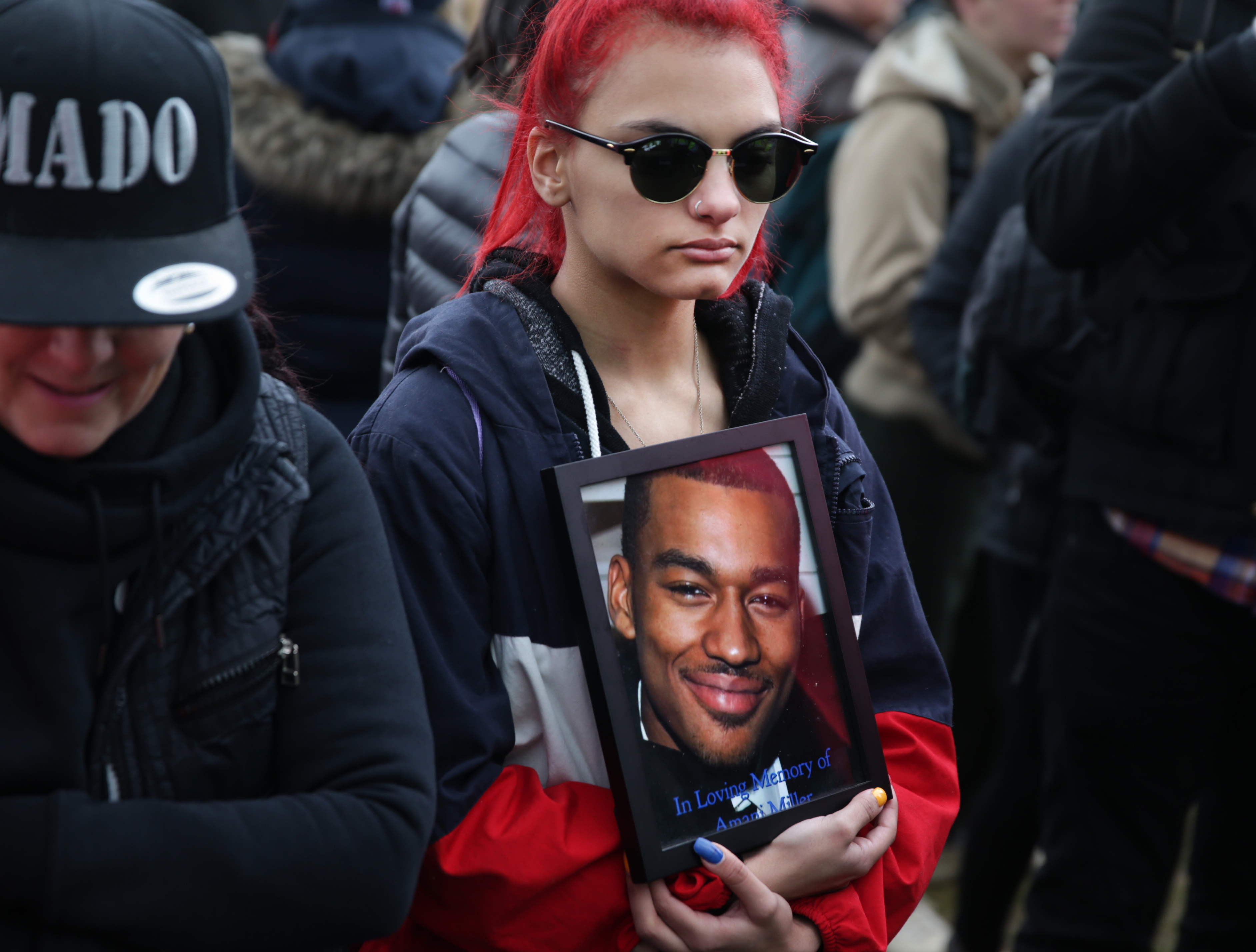 Starr Felder held a photograph of her cousin Amani Miller, who was killed by gun violence.