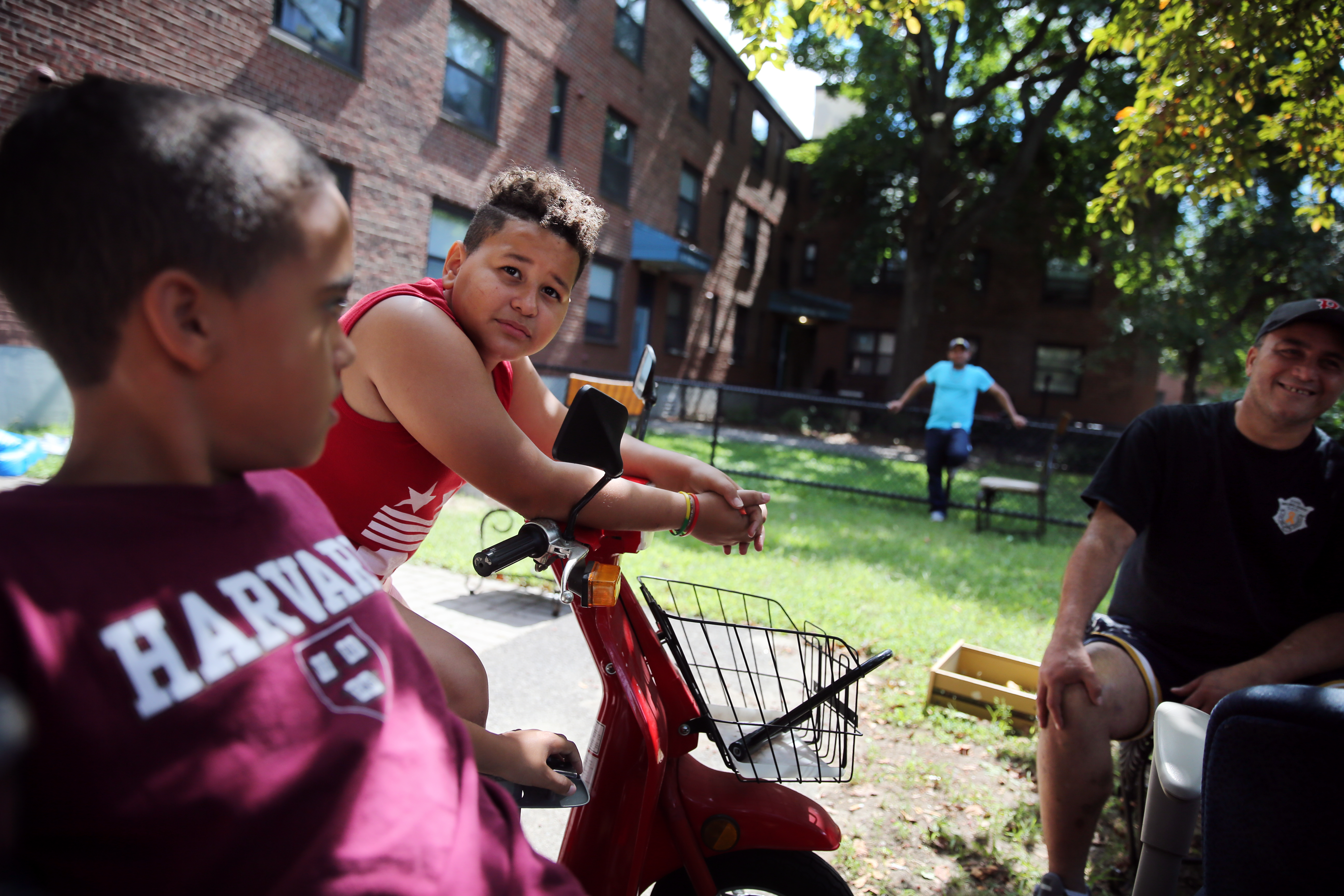 From left: Reymie Rosario, 9, Angel Pimentel Jr., 12, and Rudy Machuca talked in a Bunker Hill courtyard.
