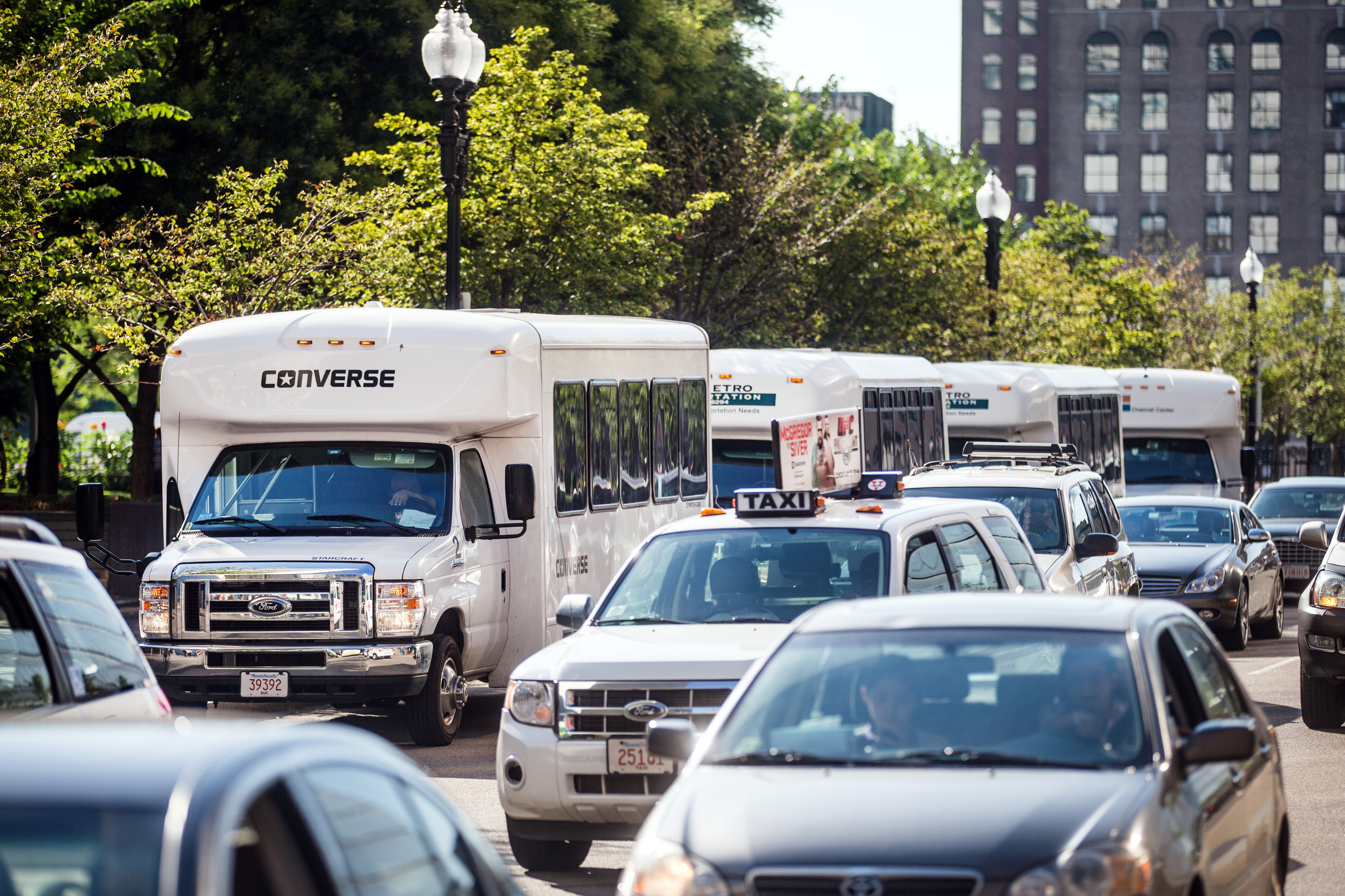 Private shuttle buses along Summer Street for company employees supplement MBTA routes.