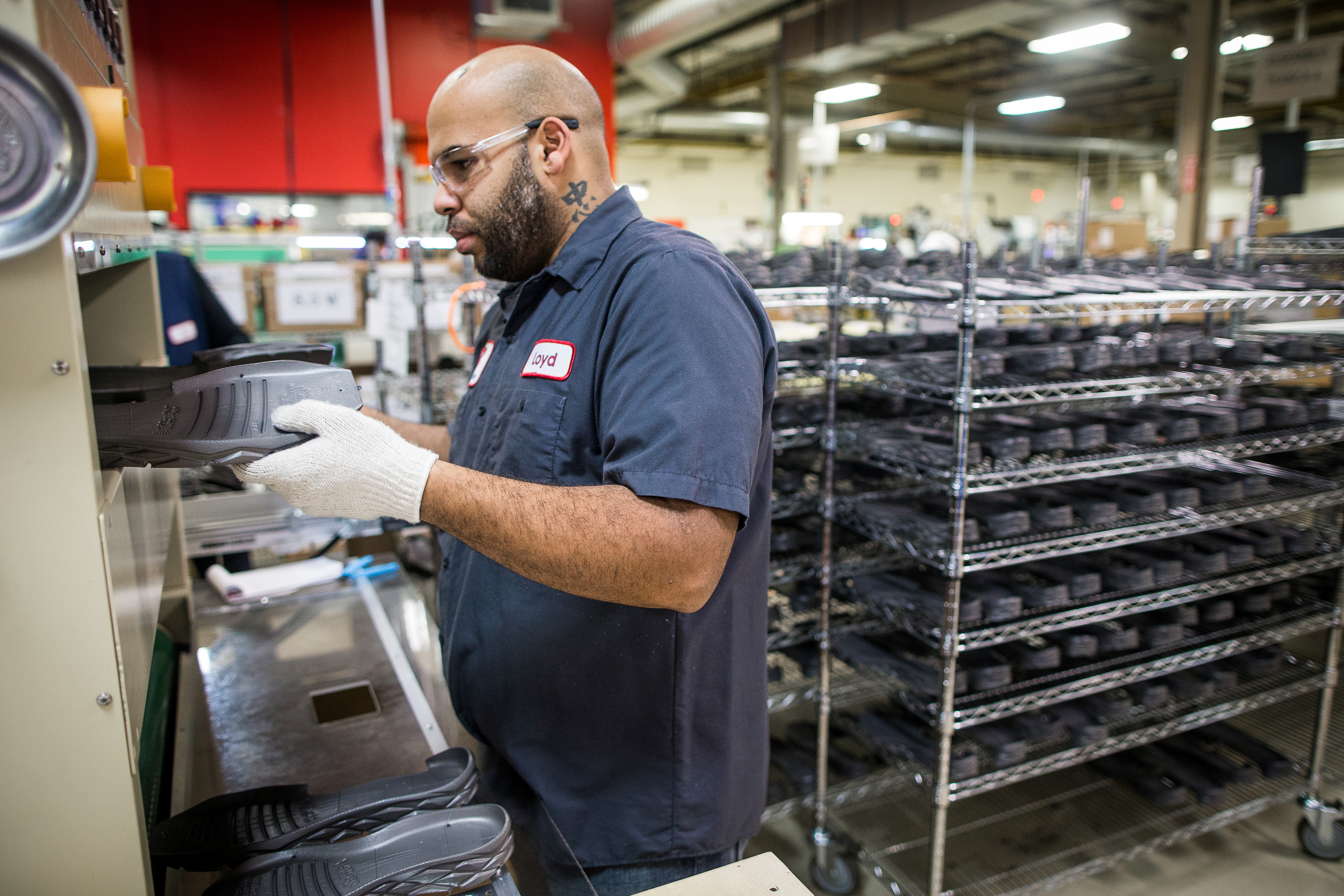 Lloyd Johnson placed midsoles into the stabilization tunnel at the New Balance manufacturing plant in Brighton.