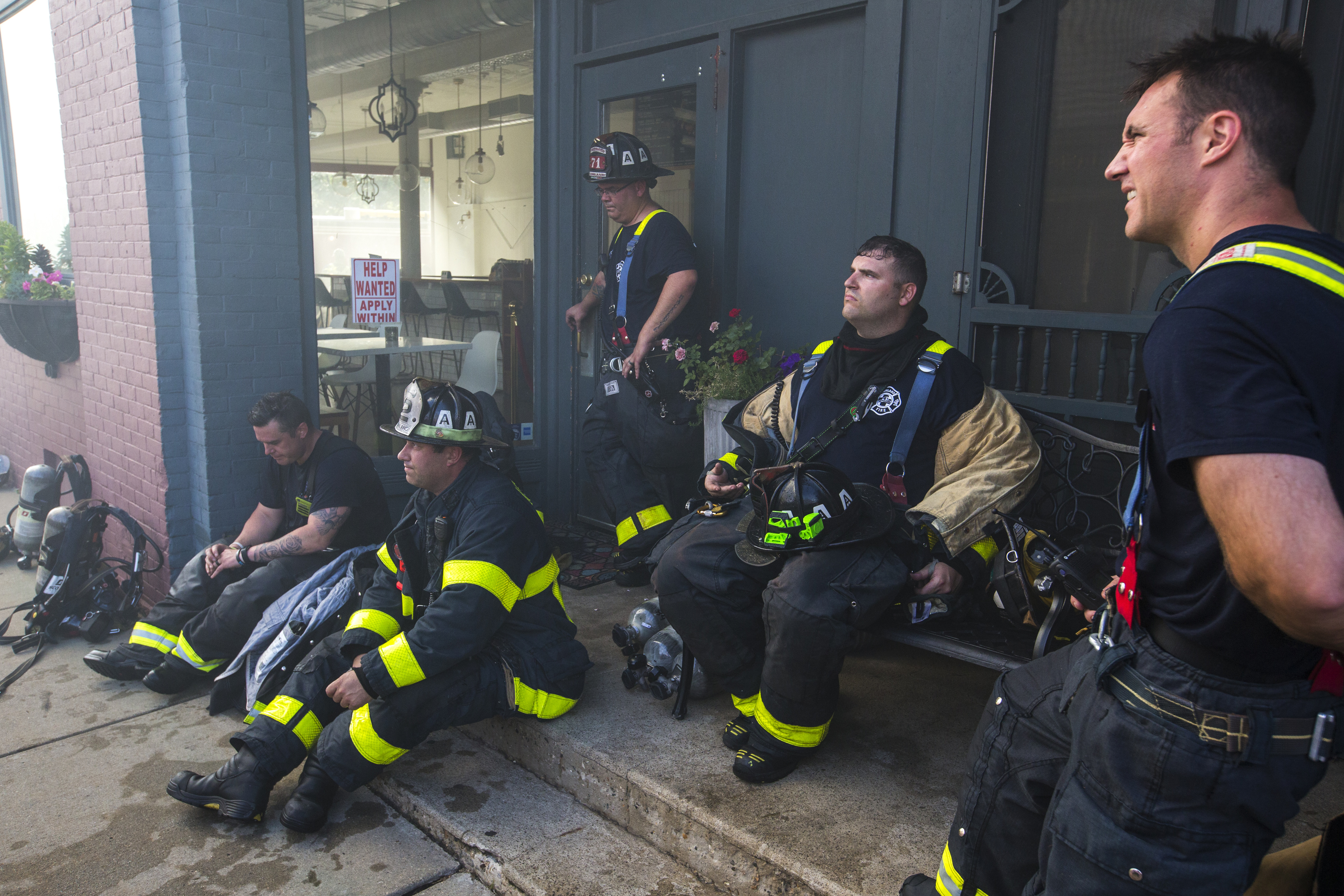 Firefighters took a break from fighting the blaze.