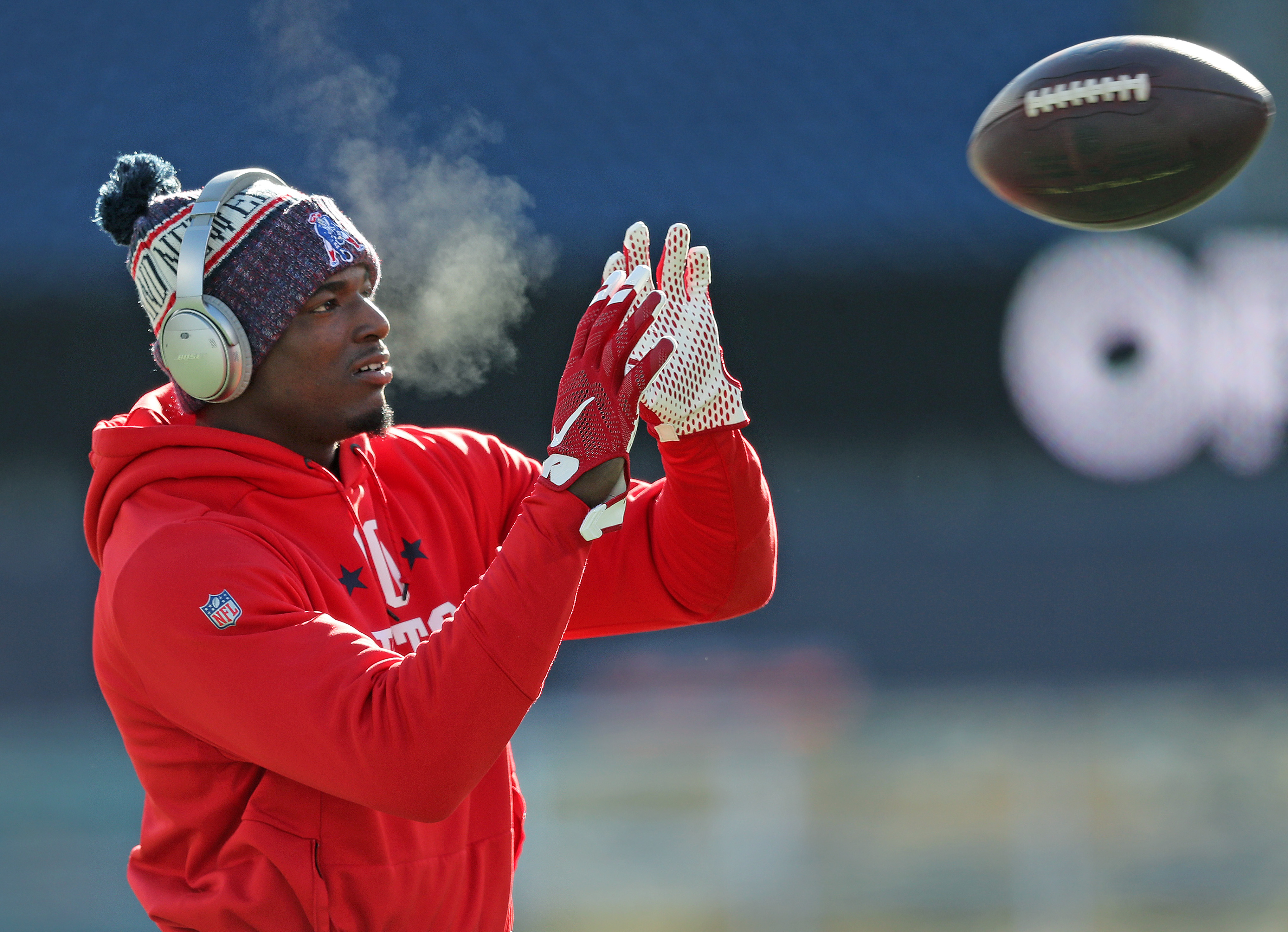Patriots CB J.C. Jackson gets loose before the game in the cold.