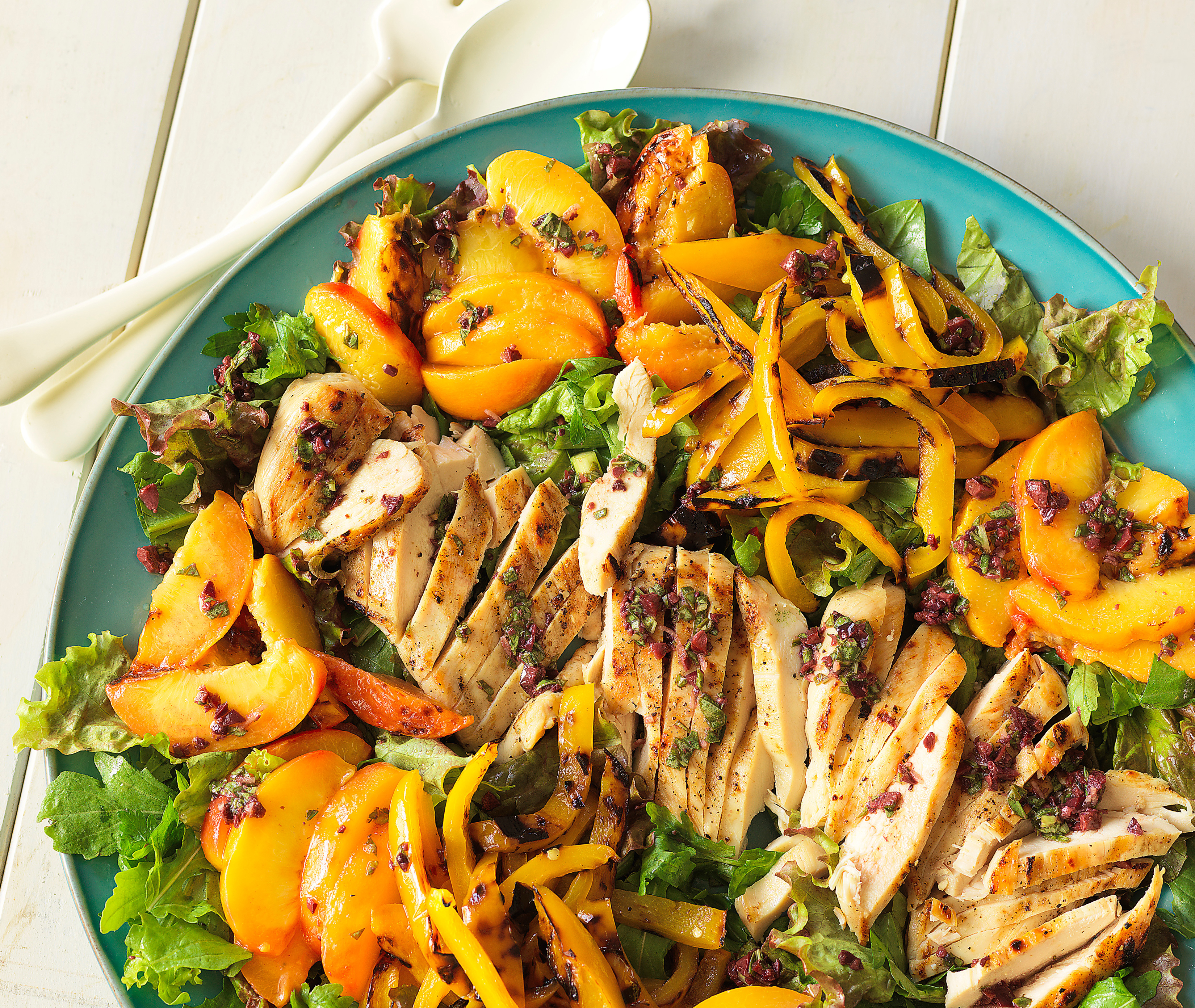 Grilled chicken and peach salad with black olive and basil vinaigrette.