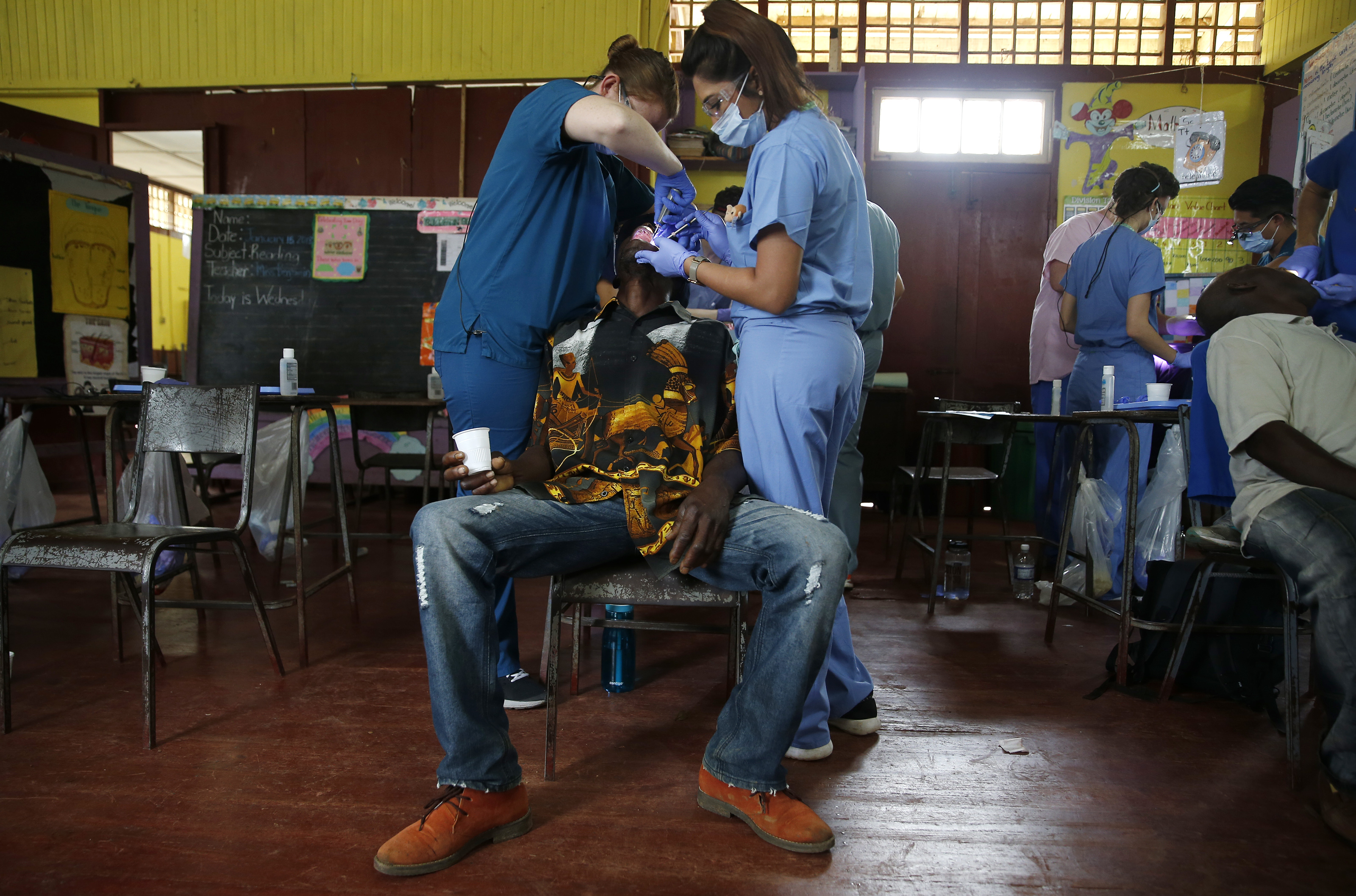 Dental students worked to extract a patient’s tooth inside the makeshift dental clinic in Mount Moriah.