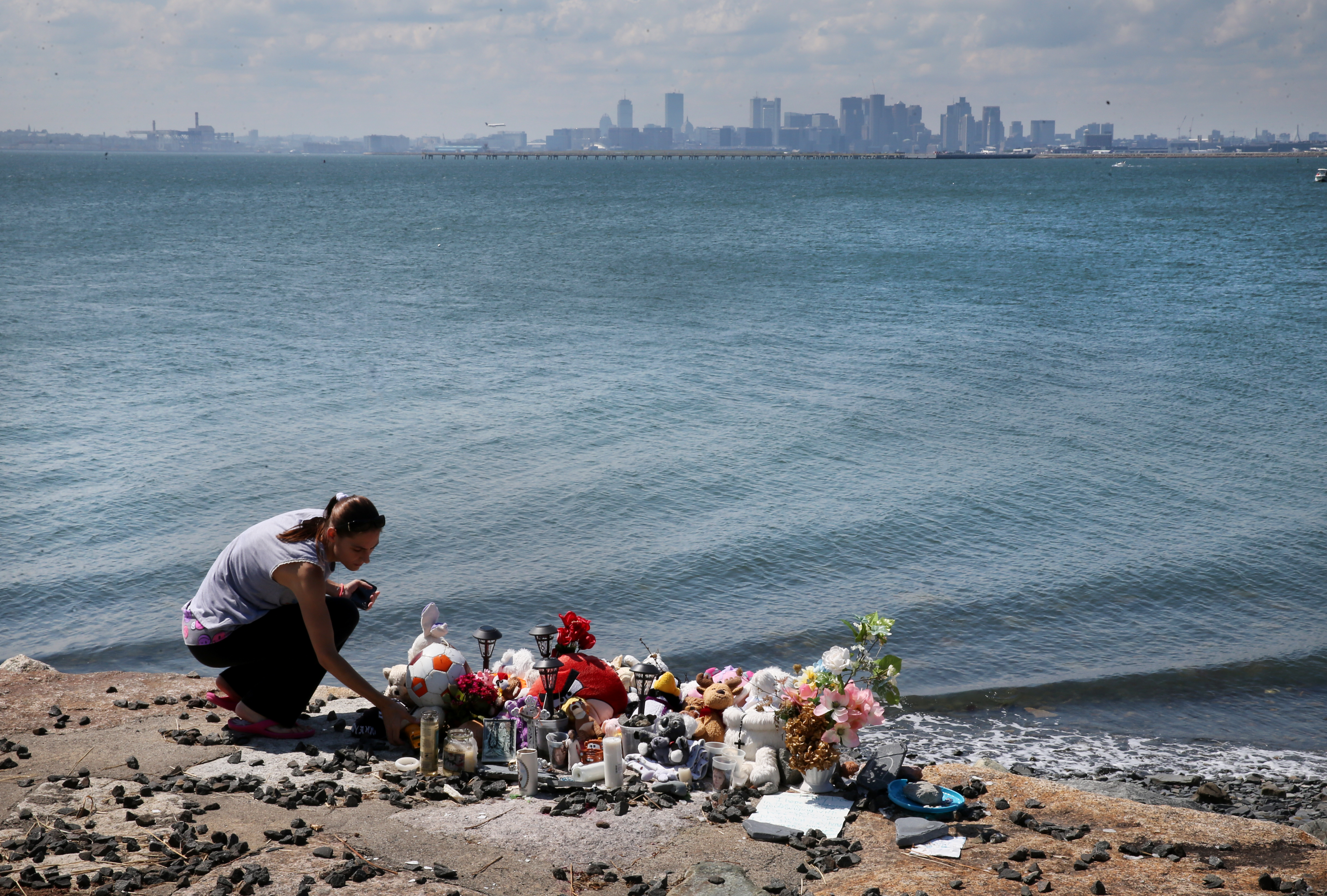 Lorraine Noel tended to the memorial at the site where Baby Doe was found at Deer Island in Winthrop.