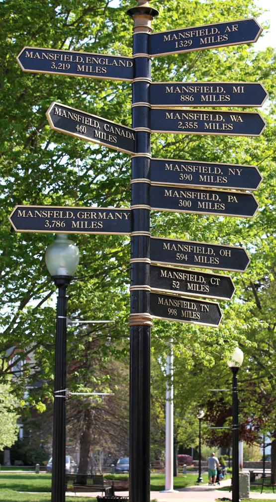 A pole on South Common points the way to Mansfields in eight states and three countries.