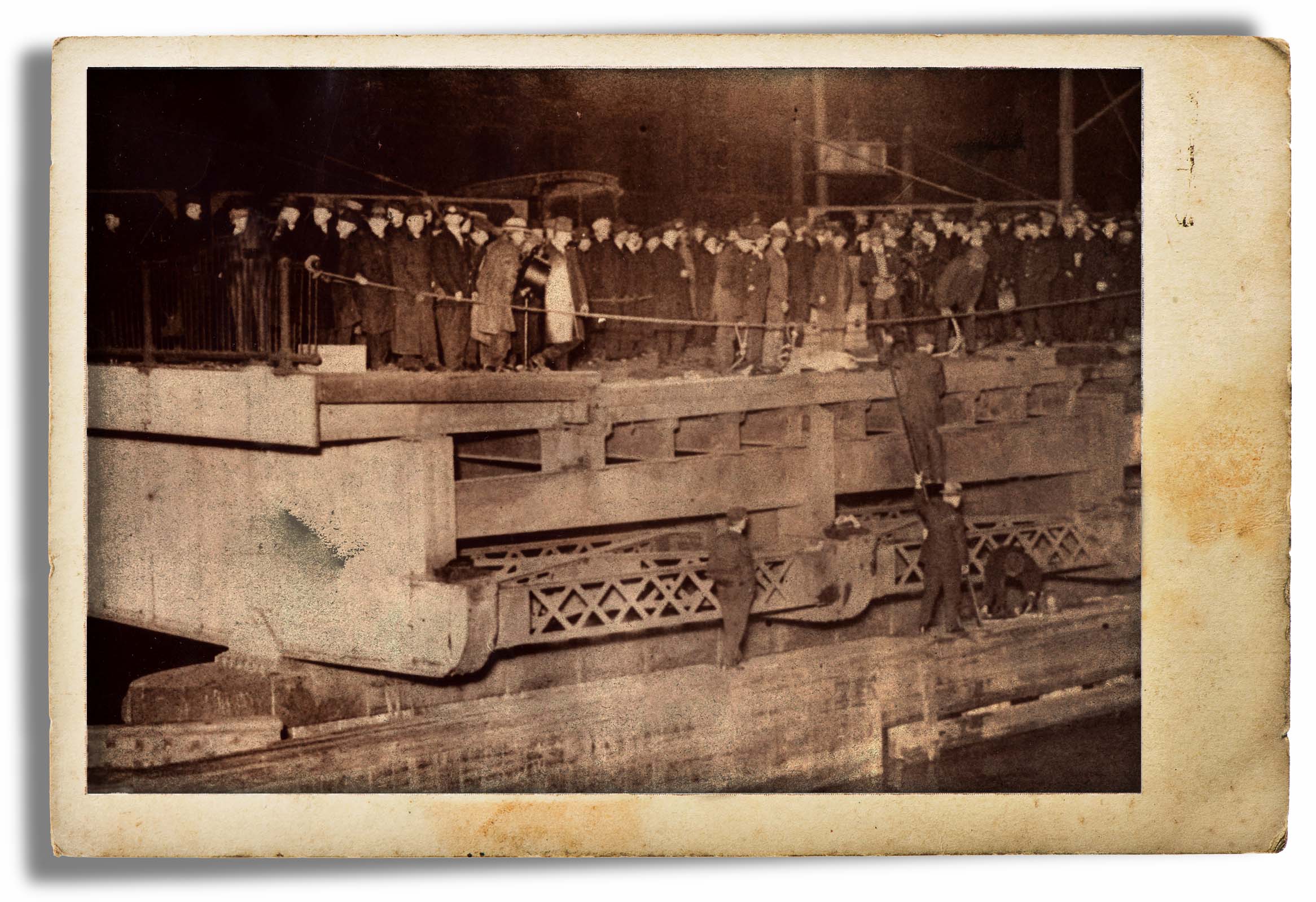 With downtown Boston crowded with rush hour commuters and people who had come out to watch the election results, a massive crowd quickly gathered around the accident scene at Fort Point Channel. This view shows the inbound deck of the open drawbridge that Car 393 had plunged from.