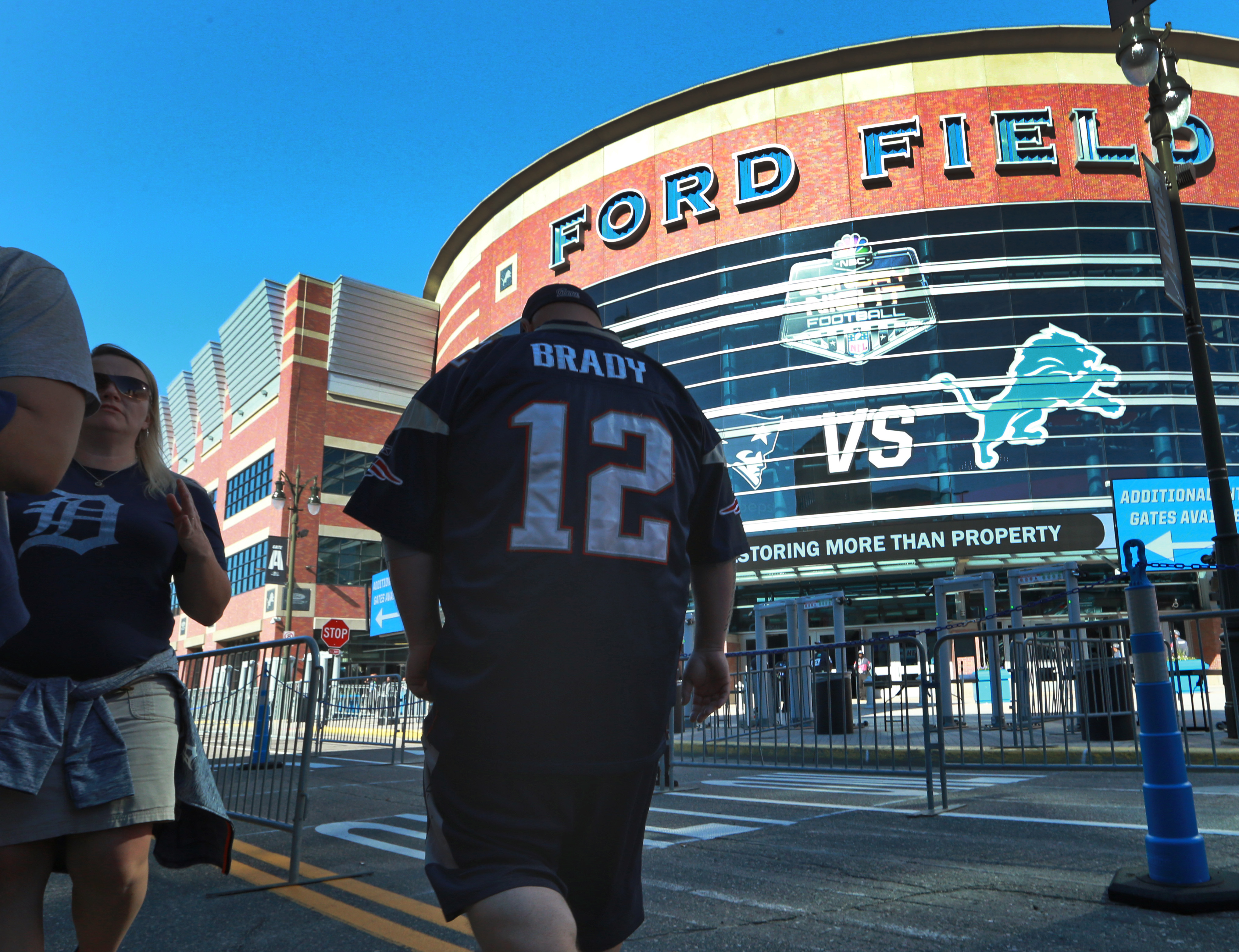 After the Tigers baseball game ended at Comerica Park next door to Ford Field, Detroit fans were leaving the area, and at the same time, Patriots fans (right) were arriving for tonight's footbal game.