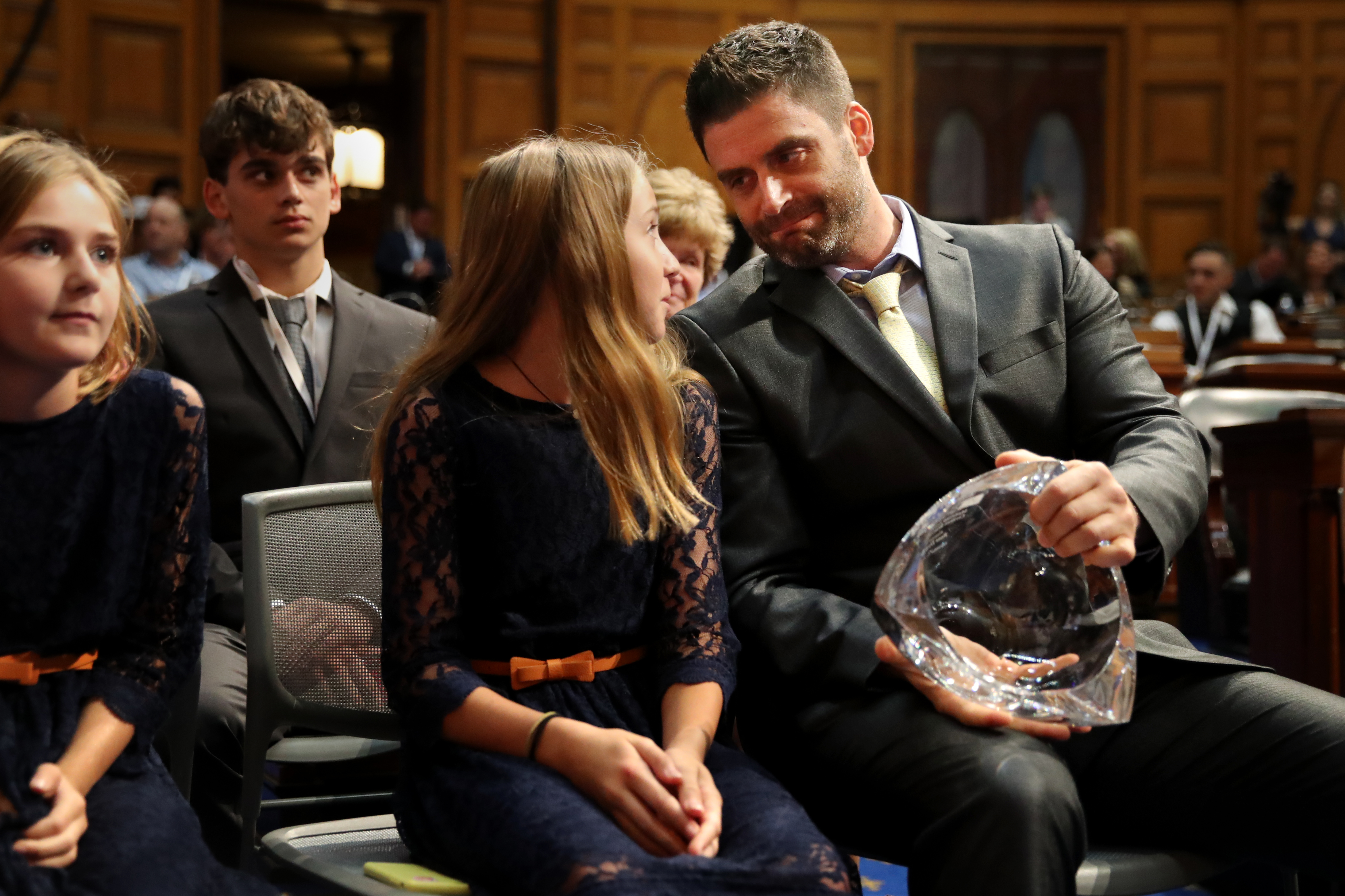 Ross Dugan talks with his daughter Brenna after being presented the Madeline Amy Sweeney Award For Civilian Bravery.